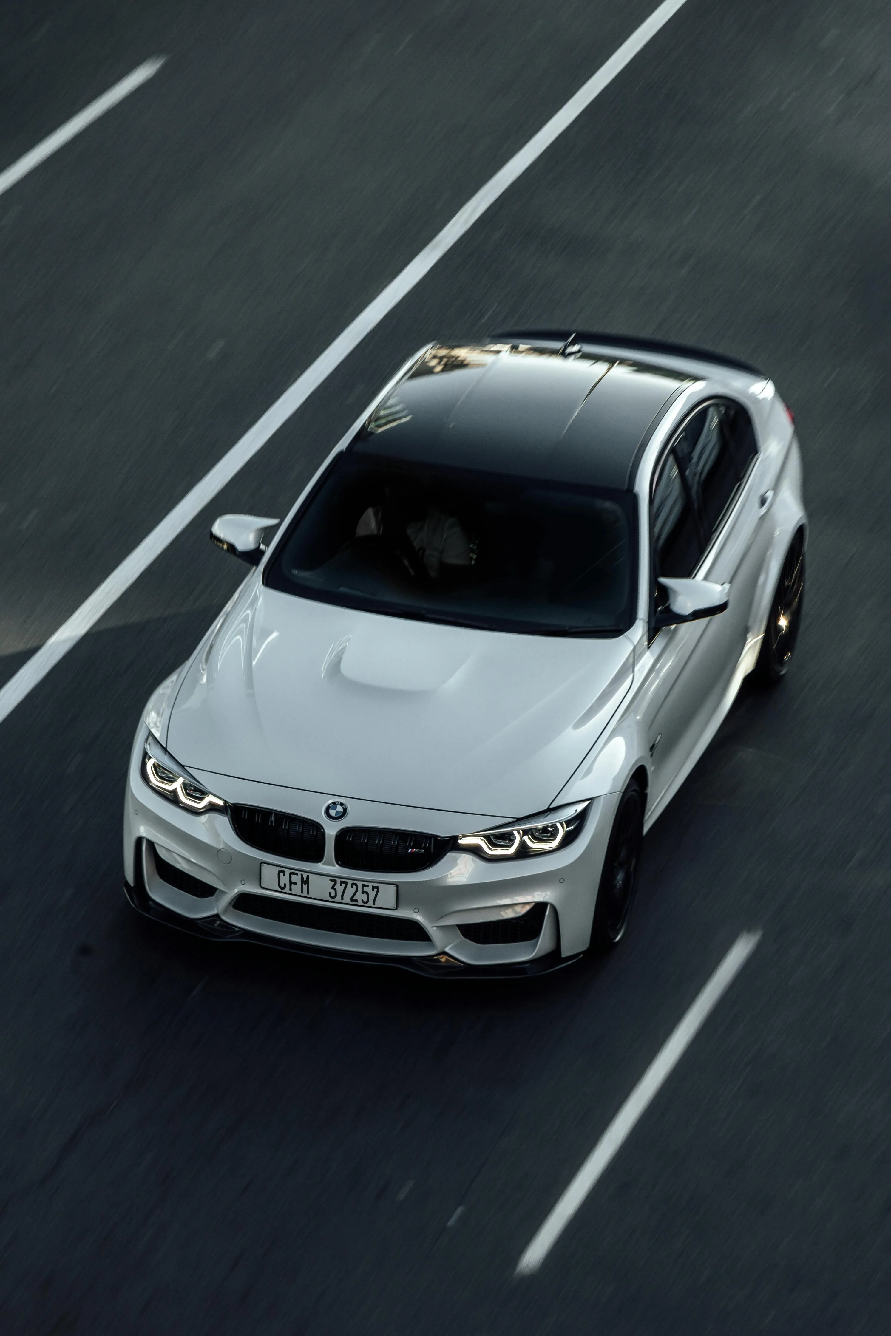 White Bmw Car Speeding on Highway with Blurred Background