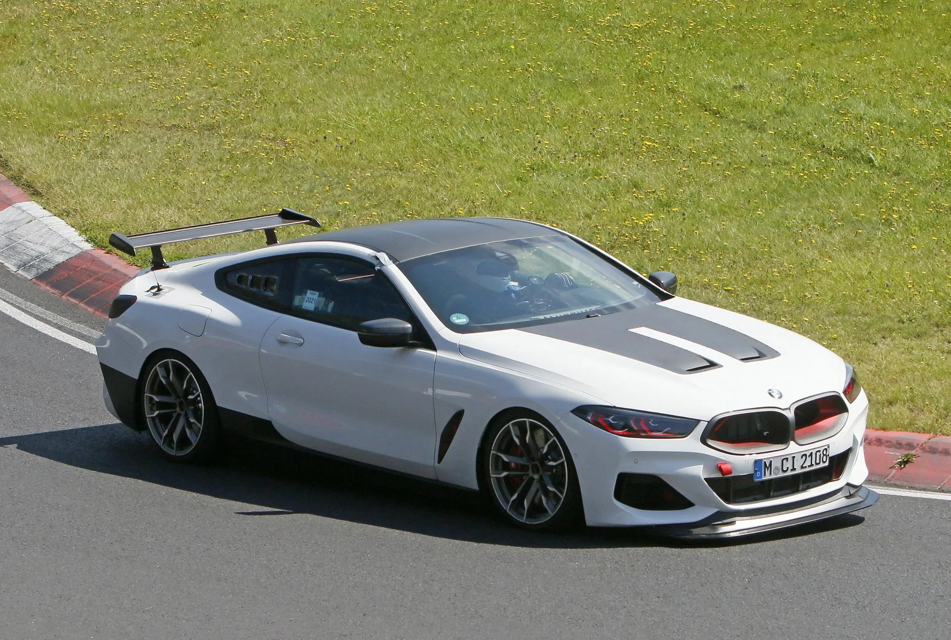 White Bmw Coupe Cornering on a Racing Track Surface