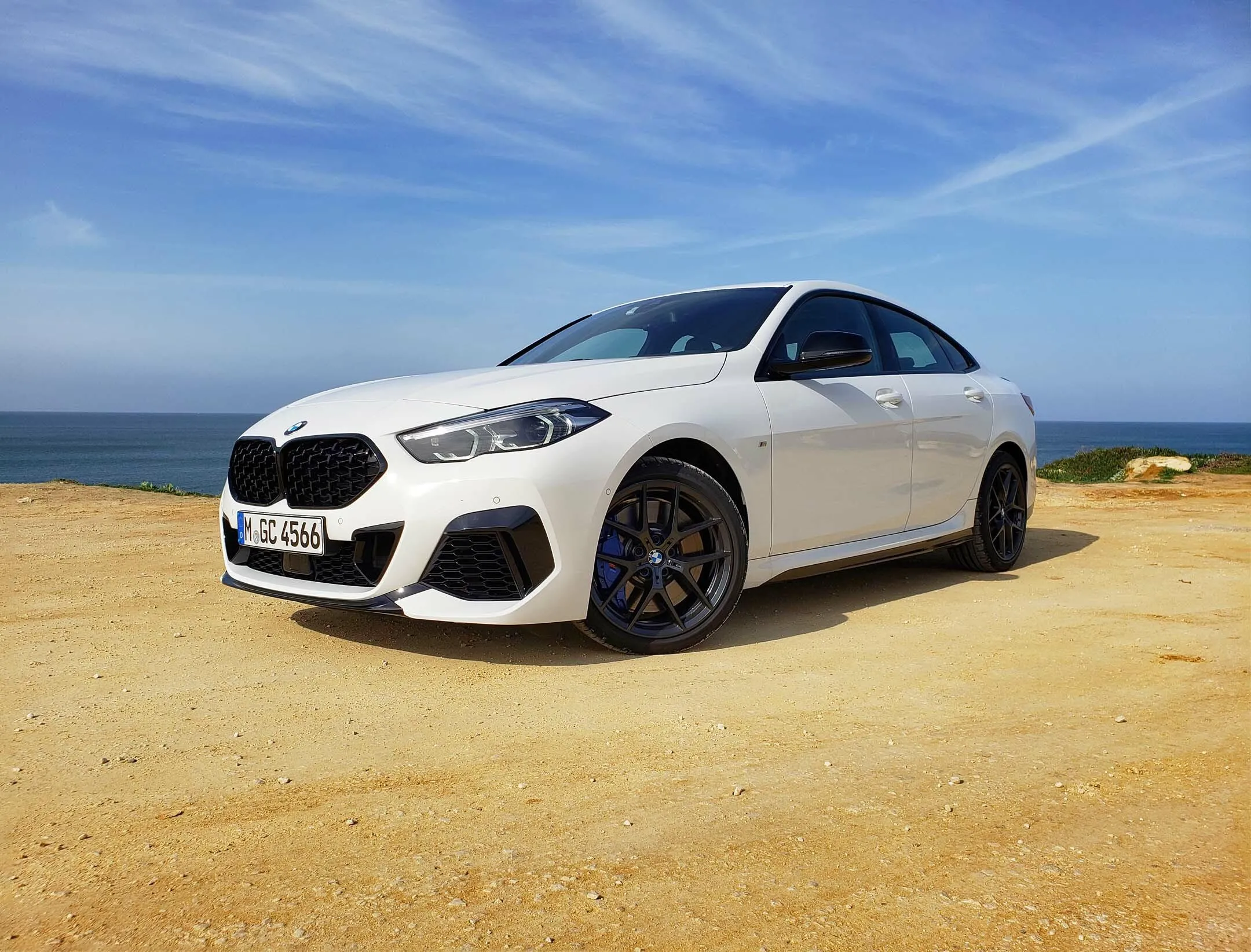 White Bmw Coupe Parked on Sandy Beach Roadside Wallpaper