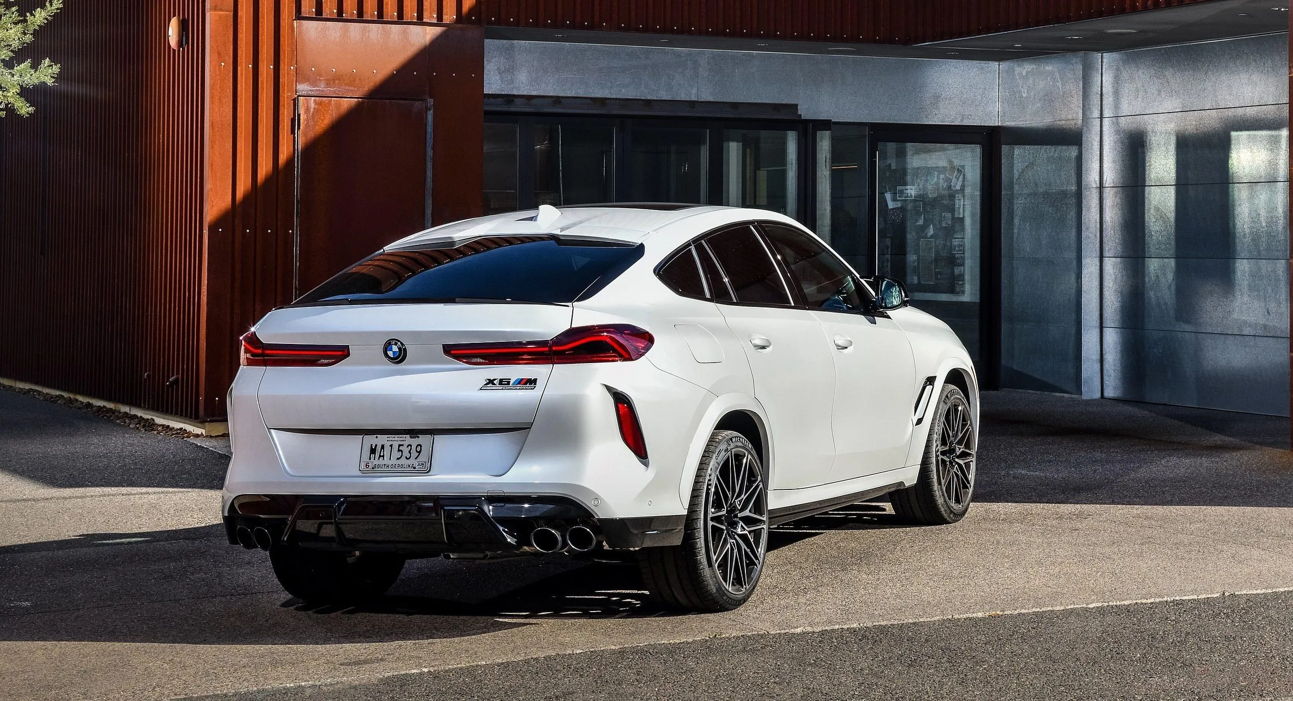 White Bmw Coupe Parked Outside a Modern House Wallpaper