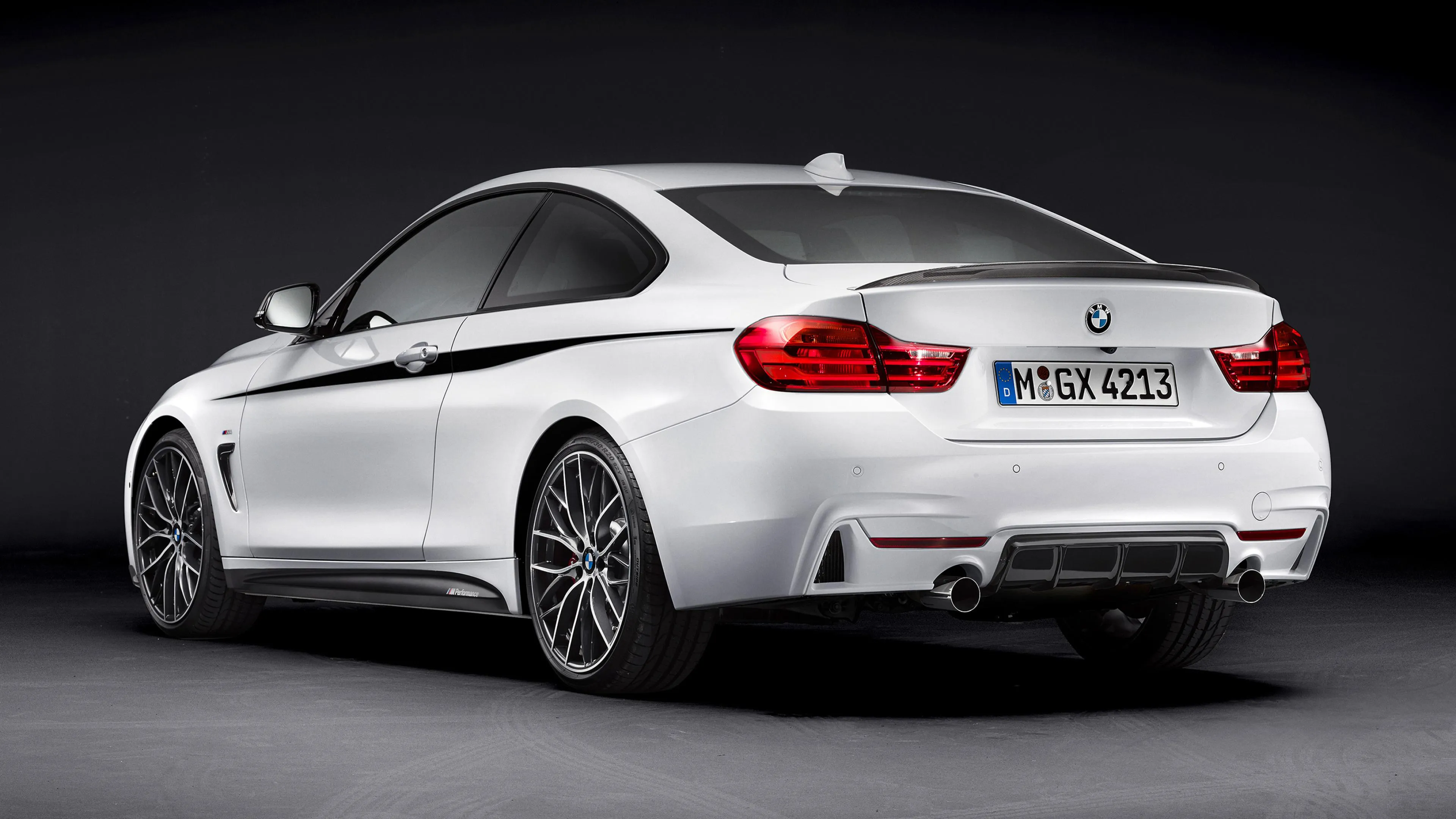 White Bmw Coupe Posed in Front of Dark Background Image