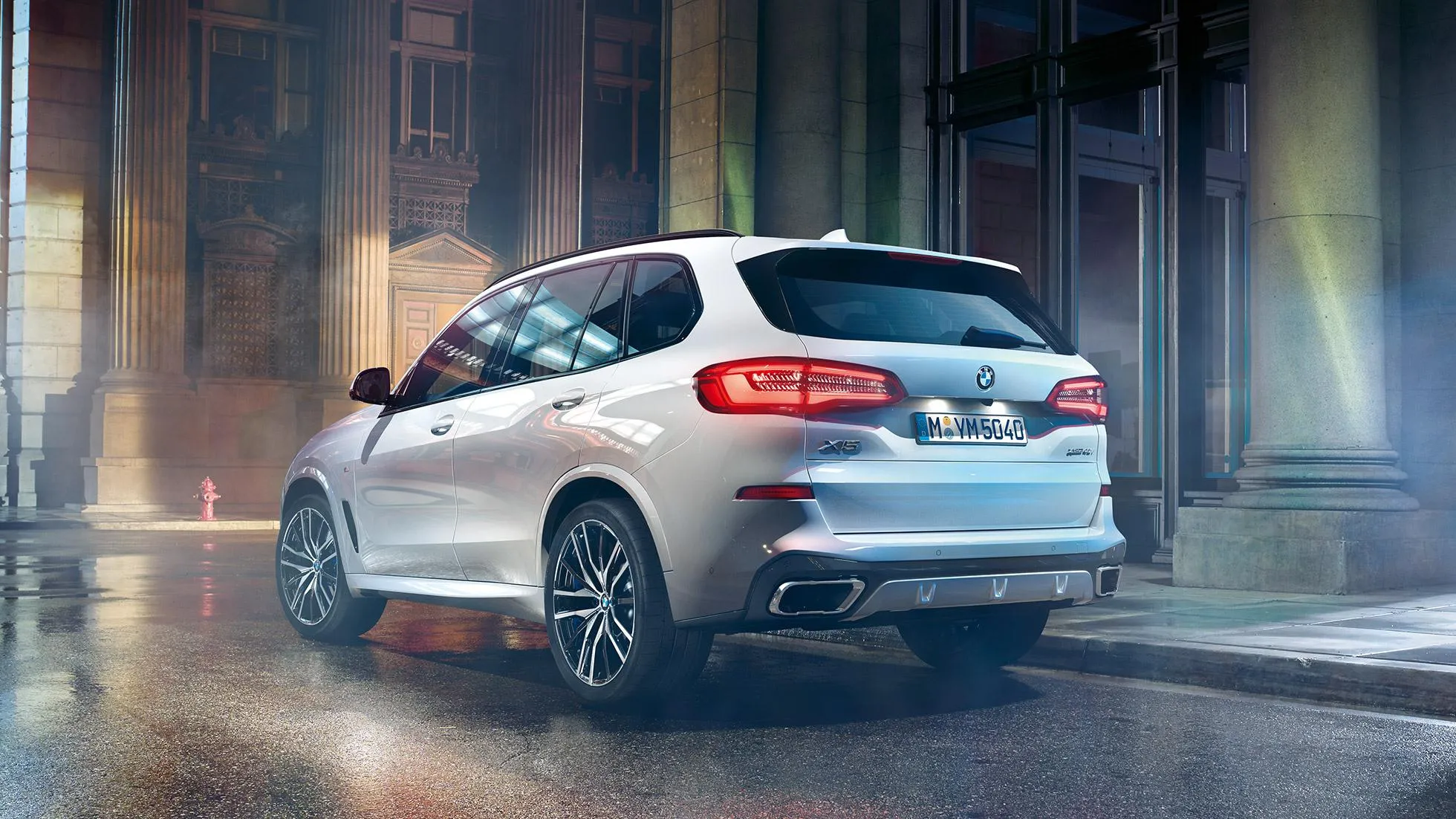 White Bmw Crossover Driving Through a Rainy Street