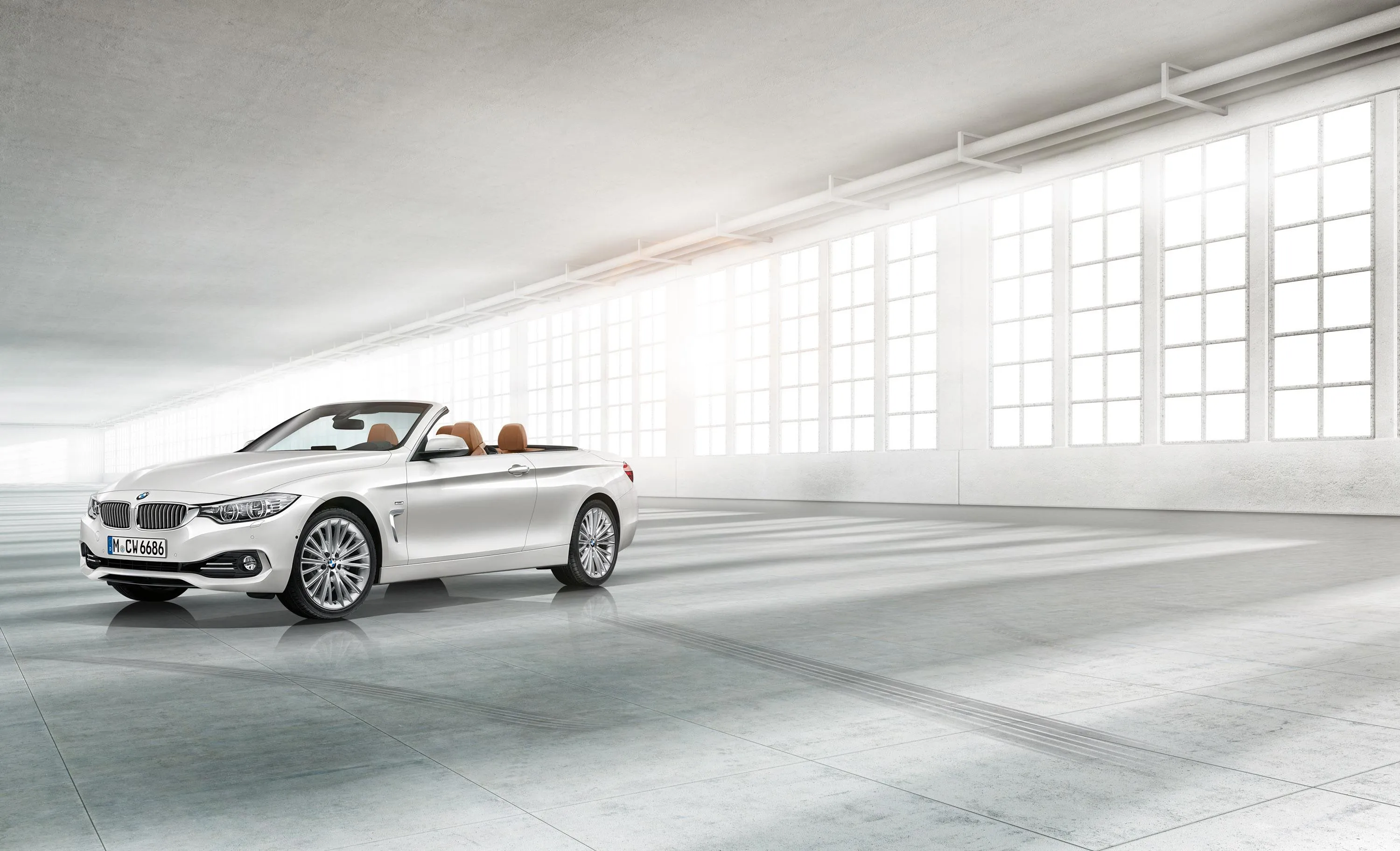 White Bmw Driving in Large Bright Indoor Showroom Hall