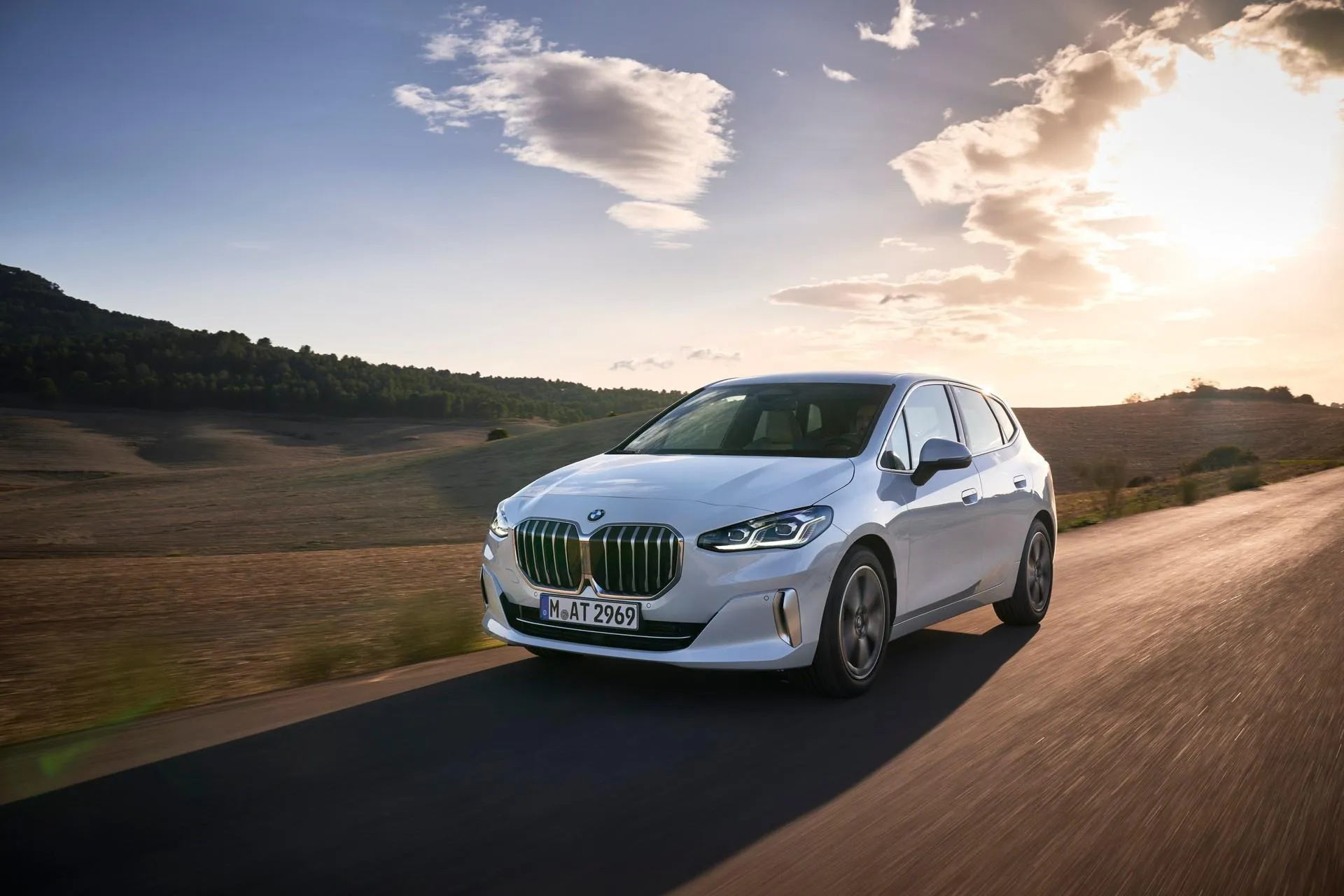 White Bmw Driving on Country Road During Sunset Time
