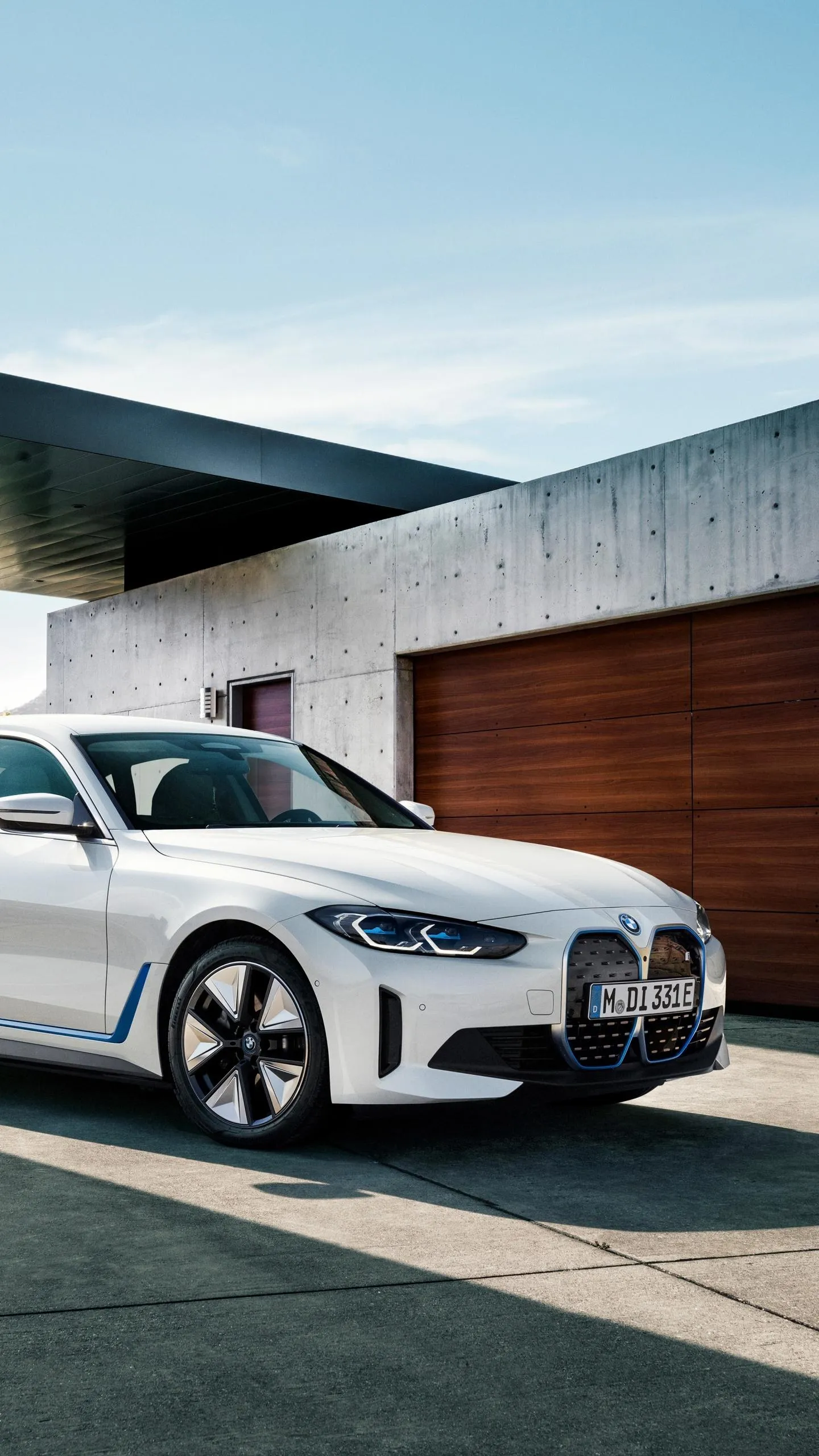White Bmw Electric Car Parked in Front of Stylish Modern Home