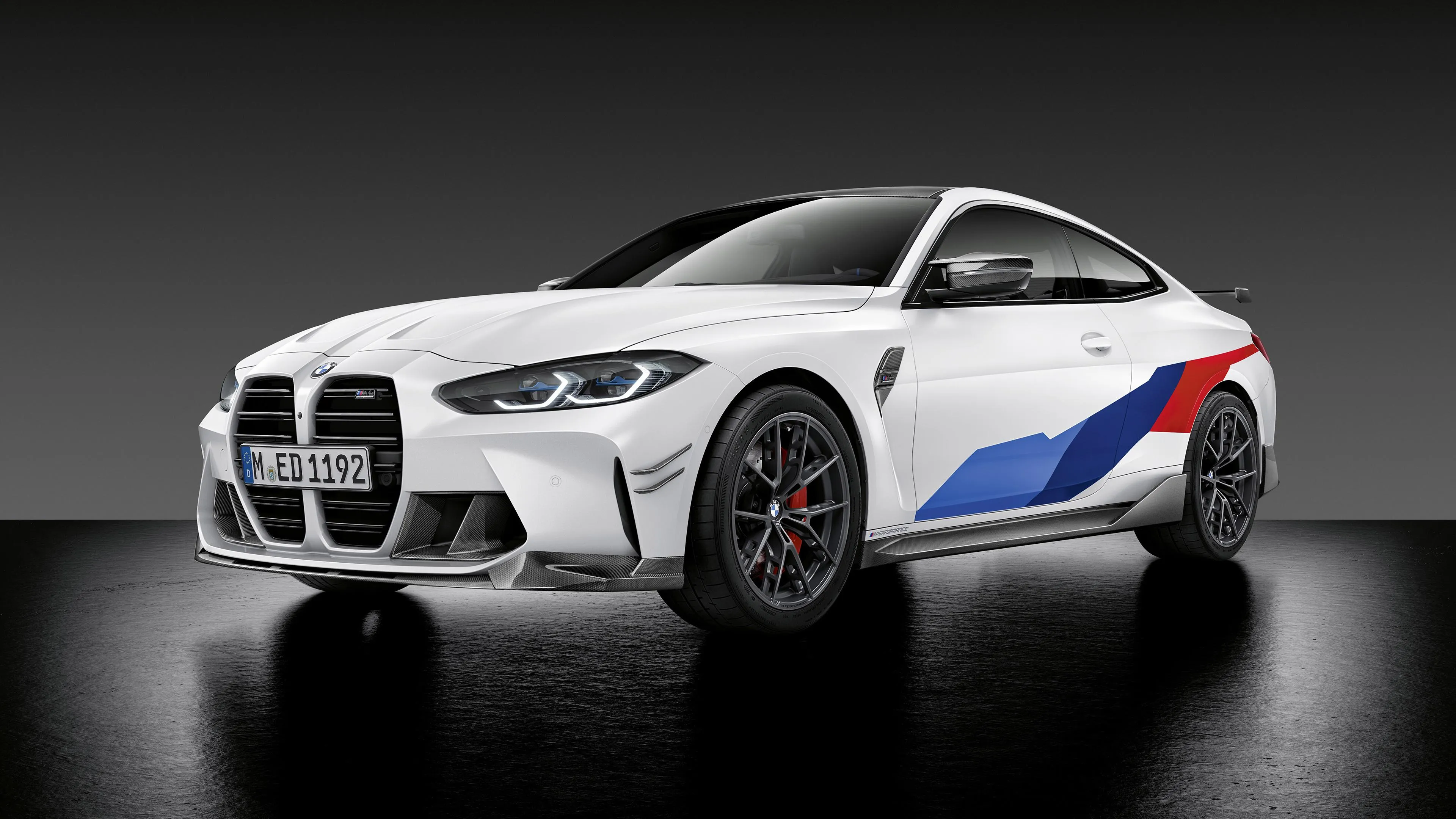 White Bmw M Series Coupe with Racing Stripes in Studio