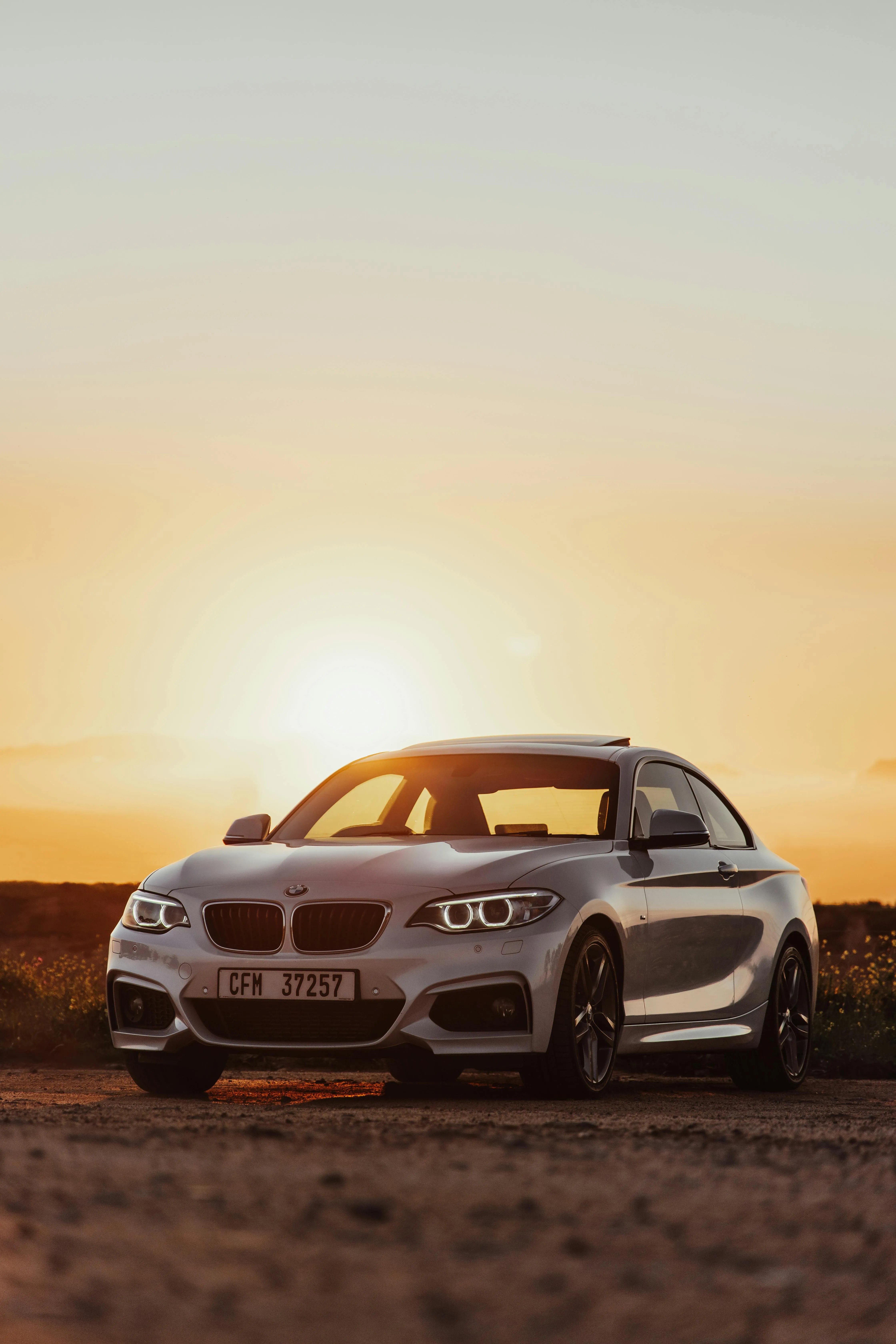 White Bmw Offroad in Desert with Sun in the Background Hd