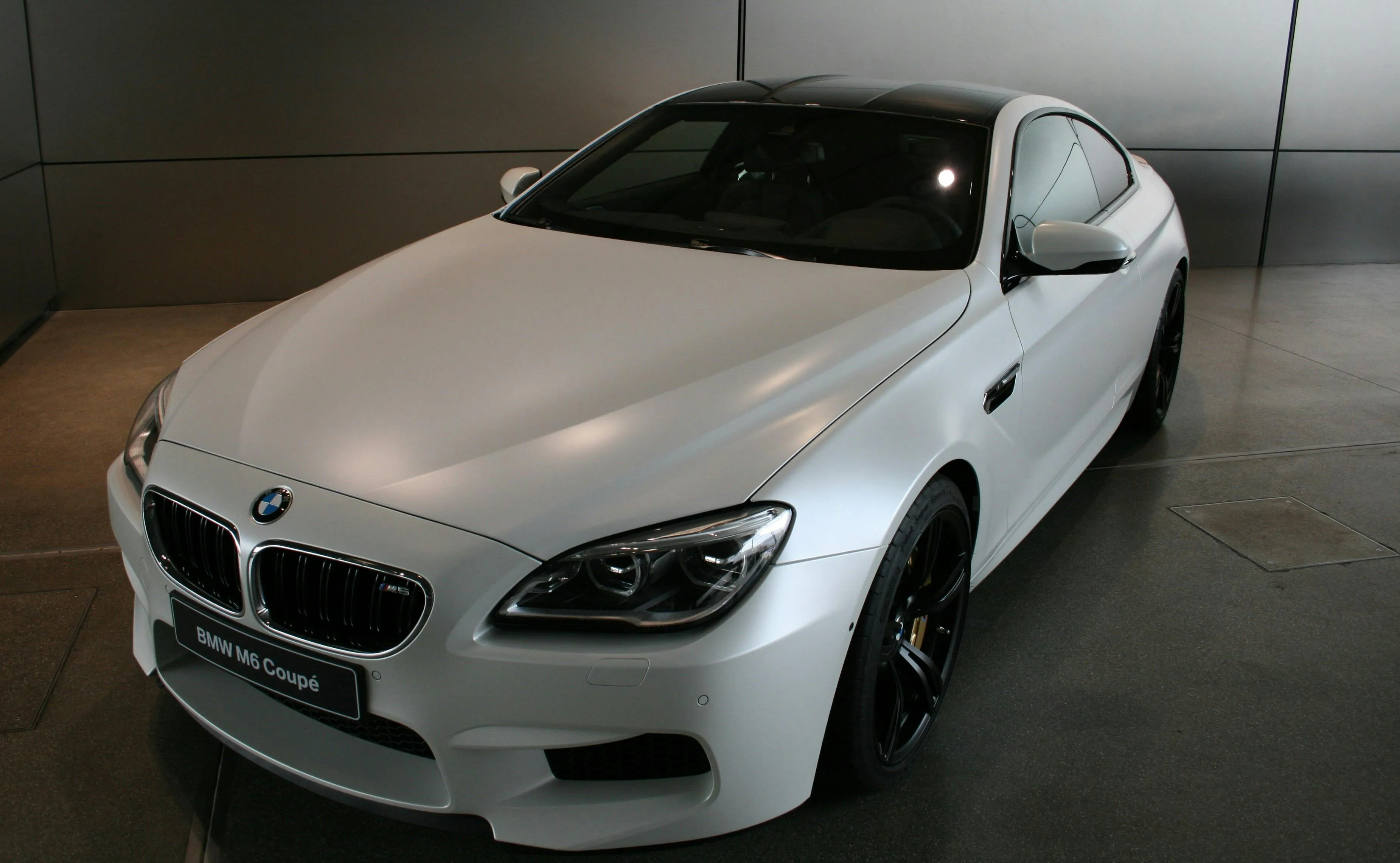 White Bmw Parked Indoors with Soft Natural Light Image