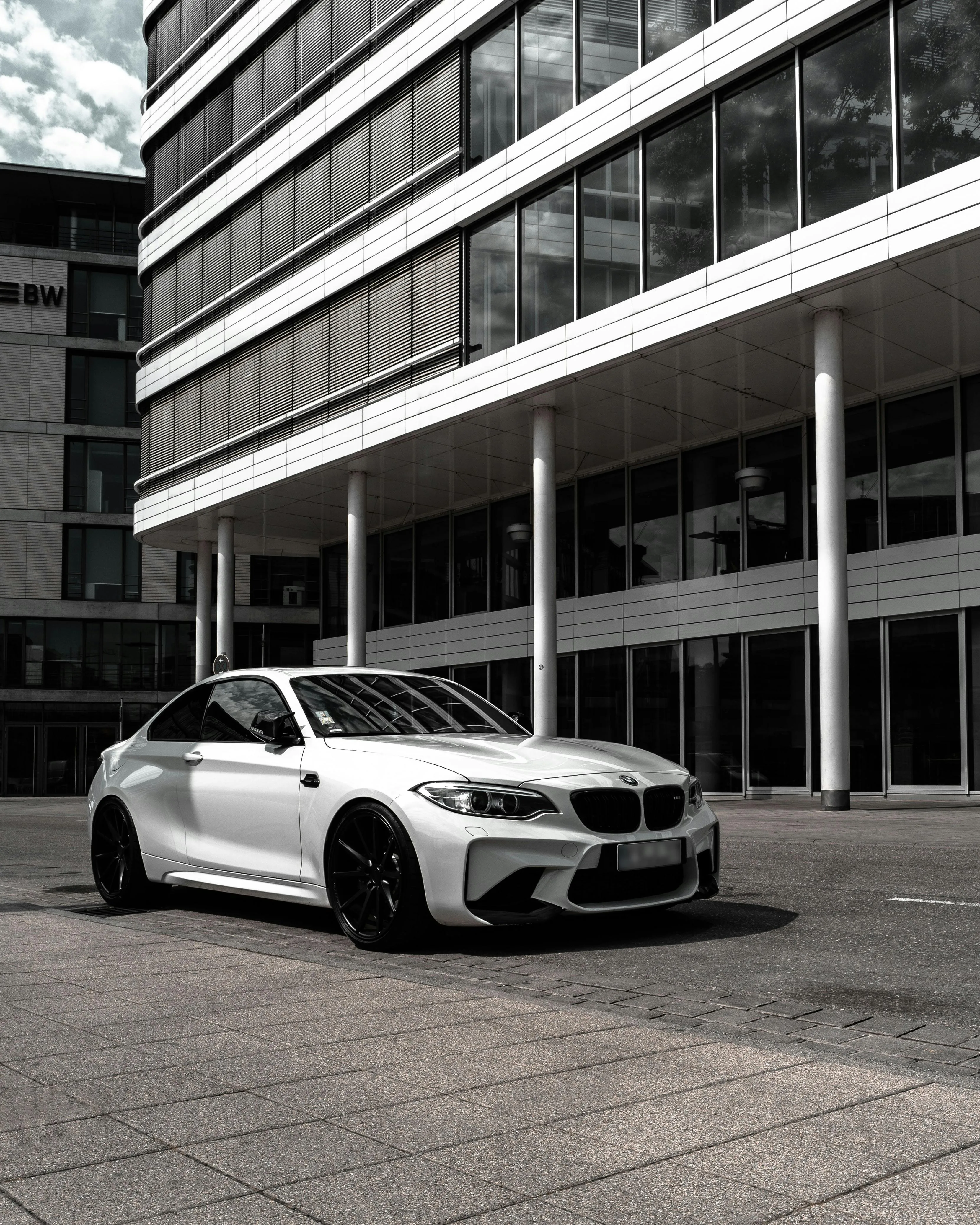 White Bmw Parked Near Office Building in Urban Area