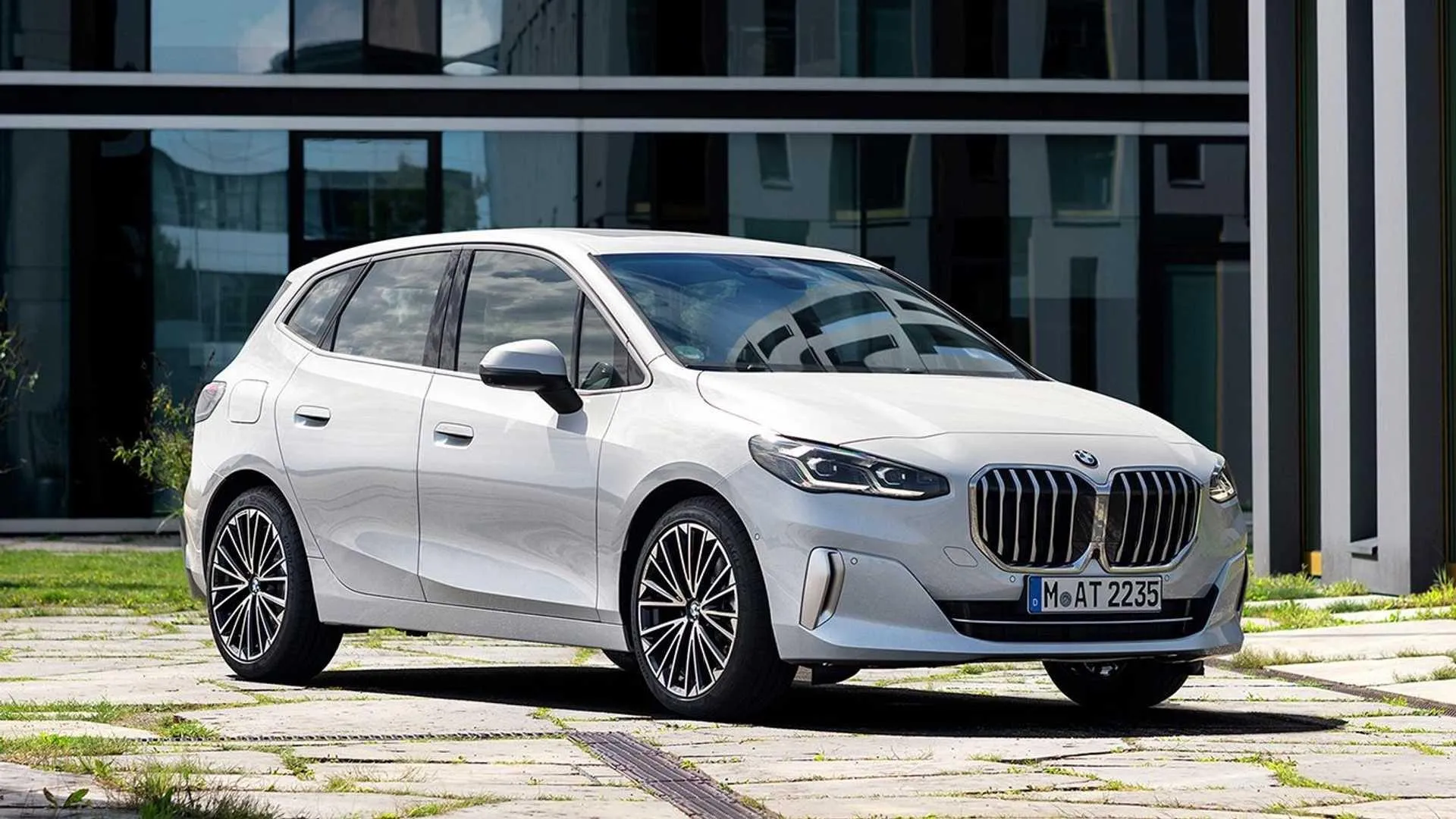 White Bmw Parked Outside a Modern Glass Building