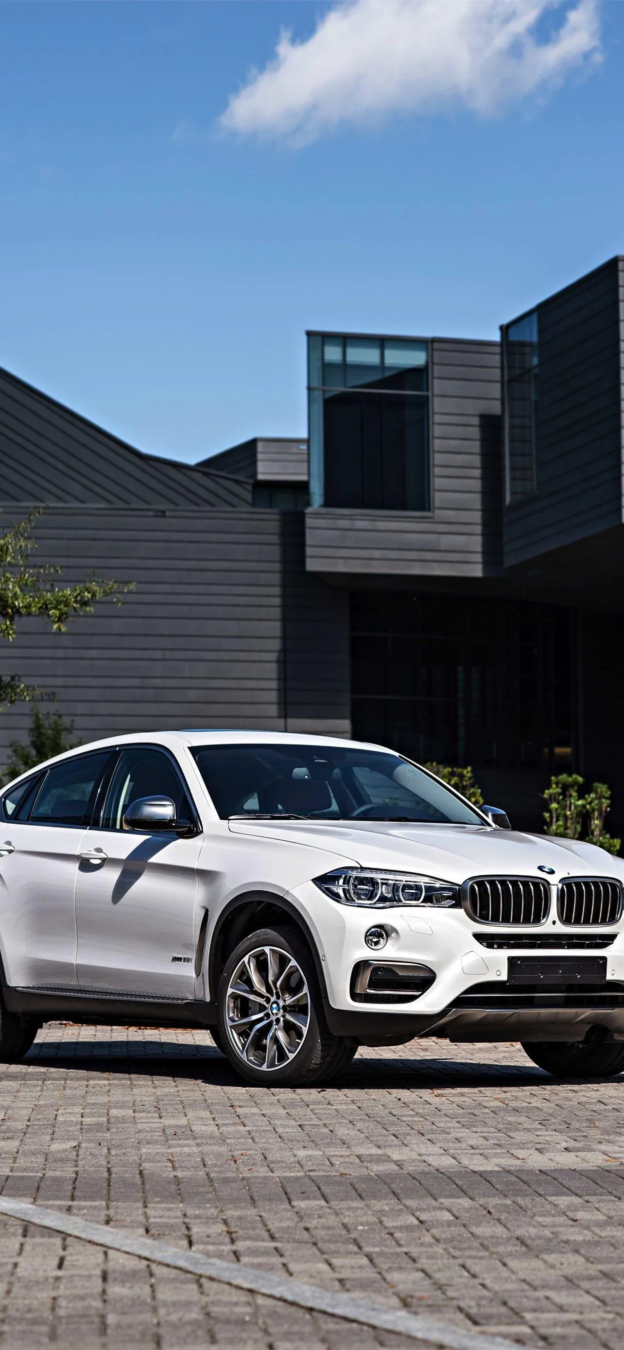 White Bmw Parked Outside Modern Office Building Wallpaper