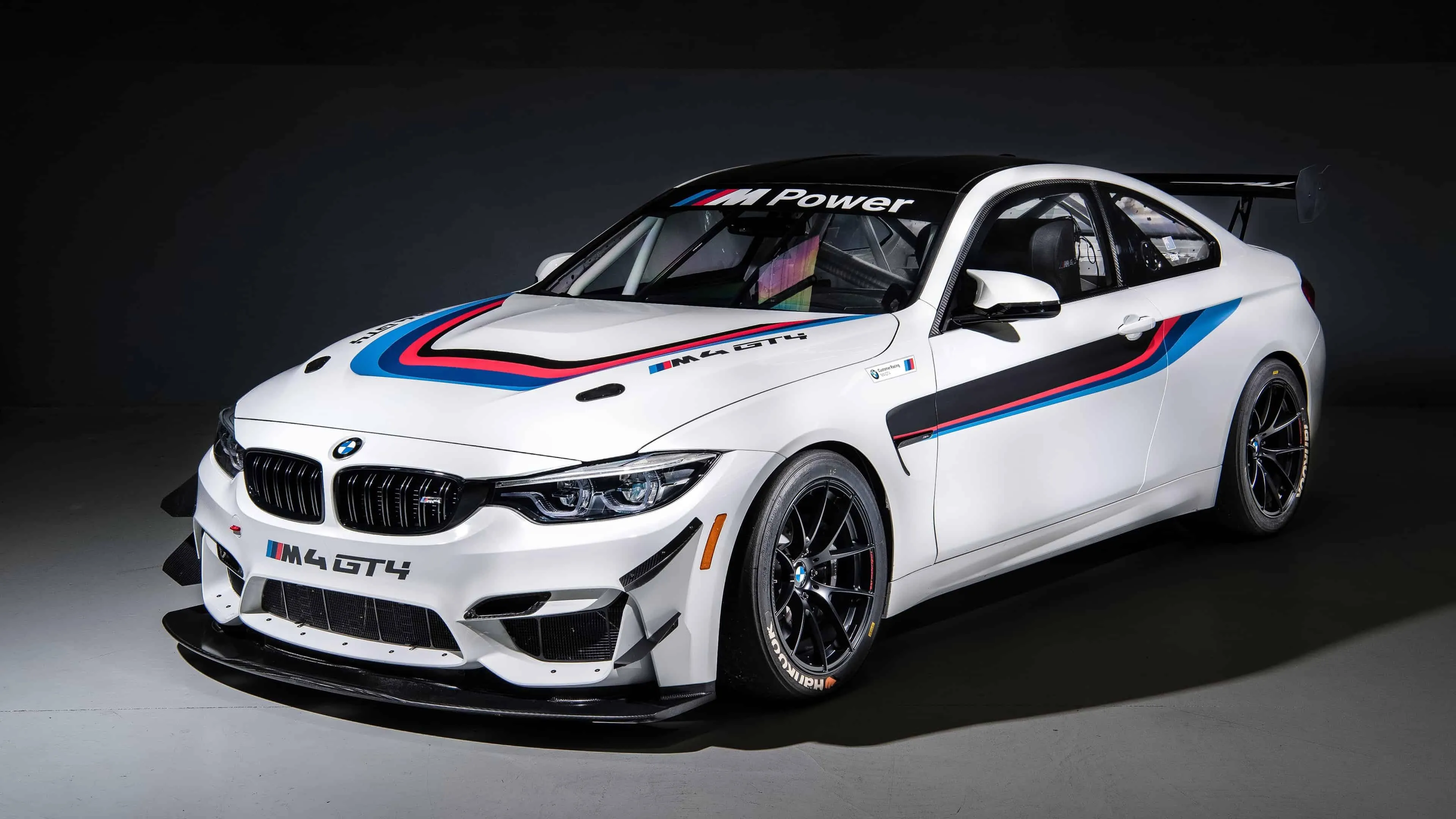 White Bmw Race Car with Decals in Studio Environment