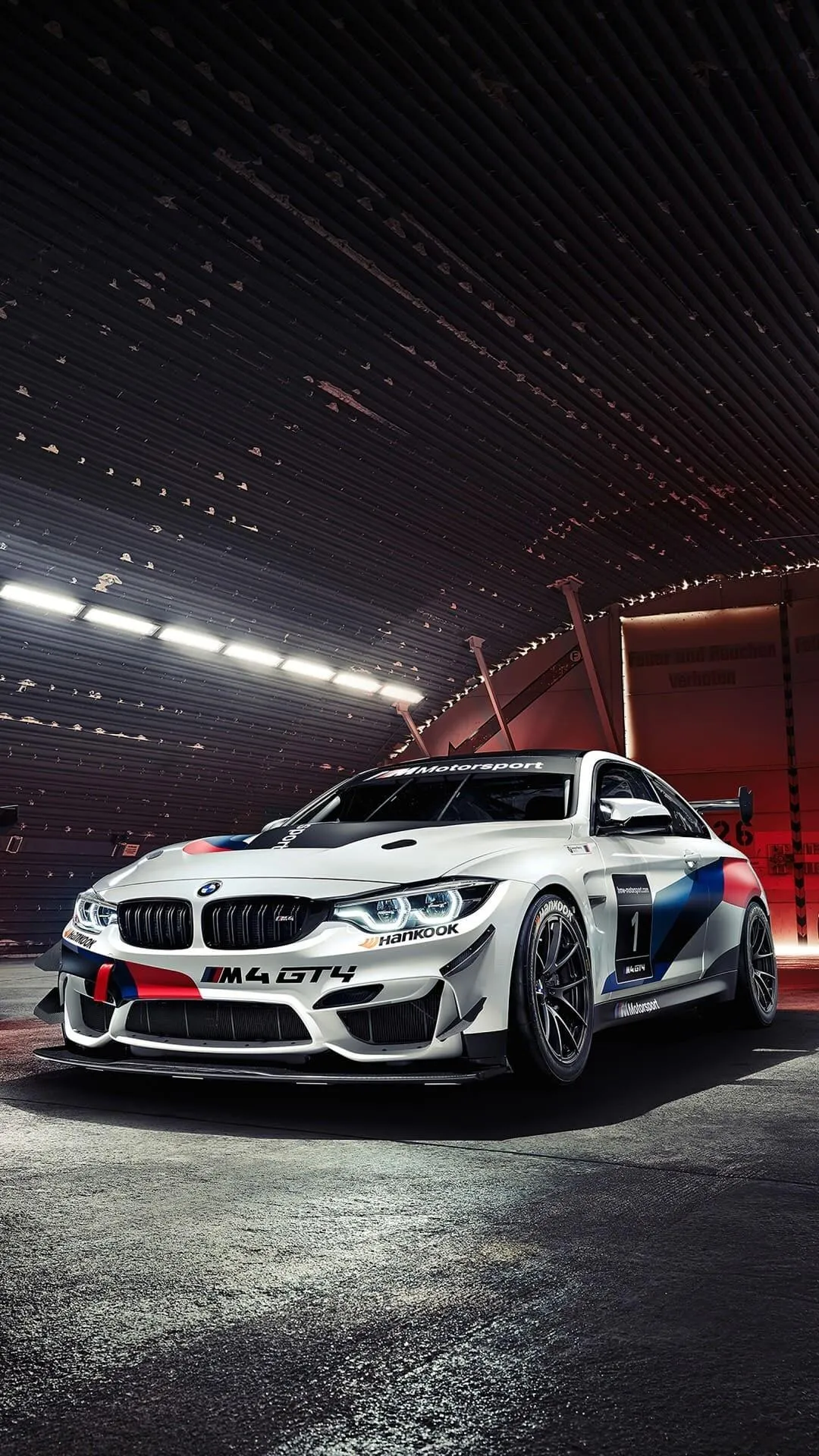 White Bmw Racing Car Inside Garage with Bright Lights
