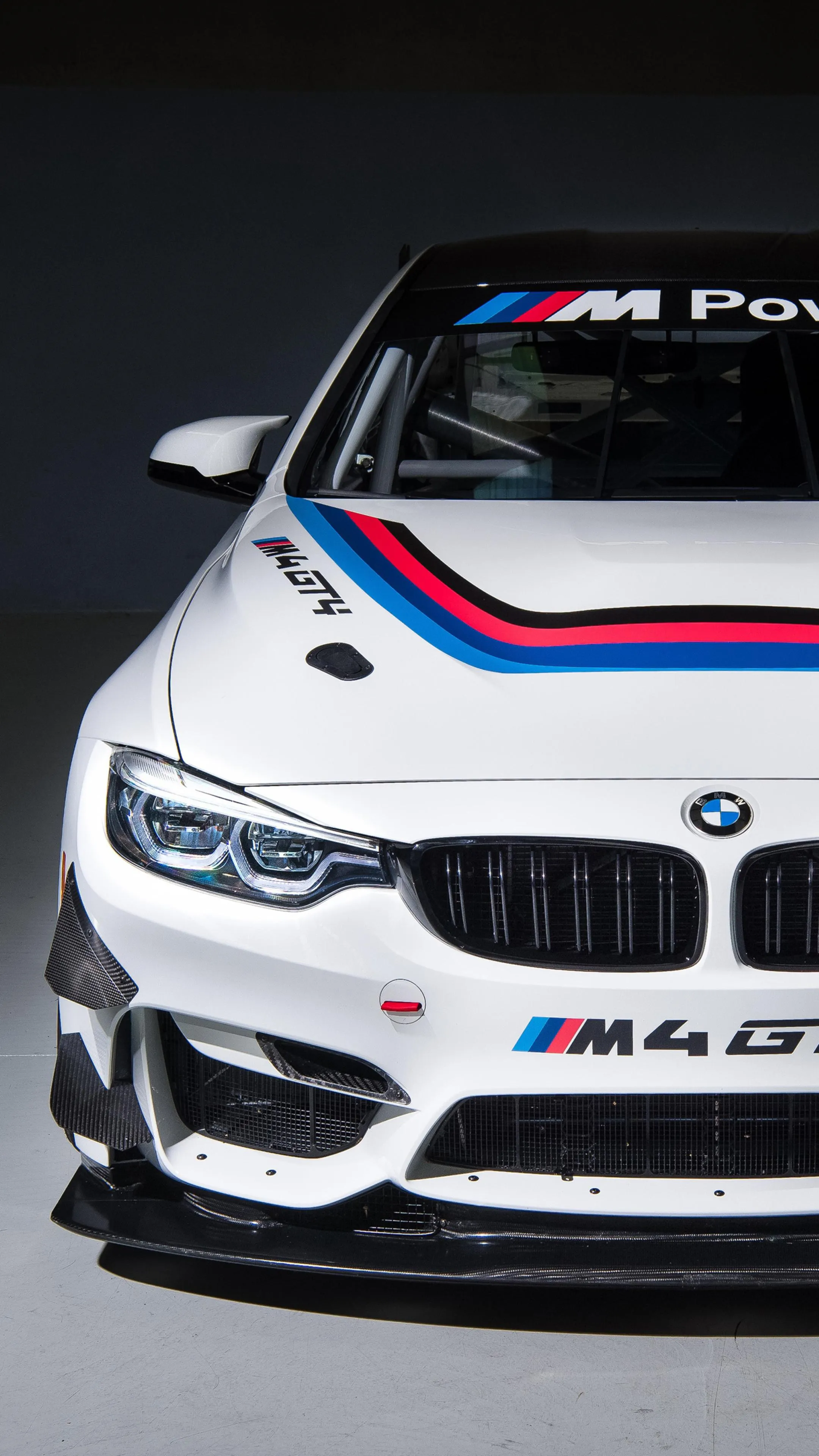 White Bmw Racing Car with Stripe Design in Spotlight