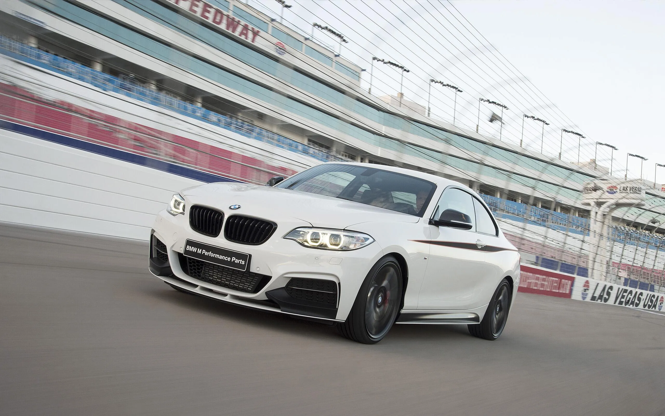 White Bmw Racing on Track with Motion Blur in Background