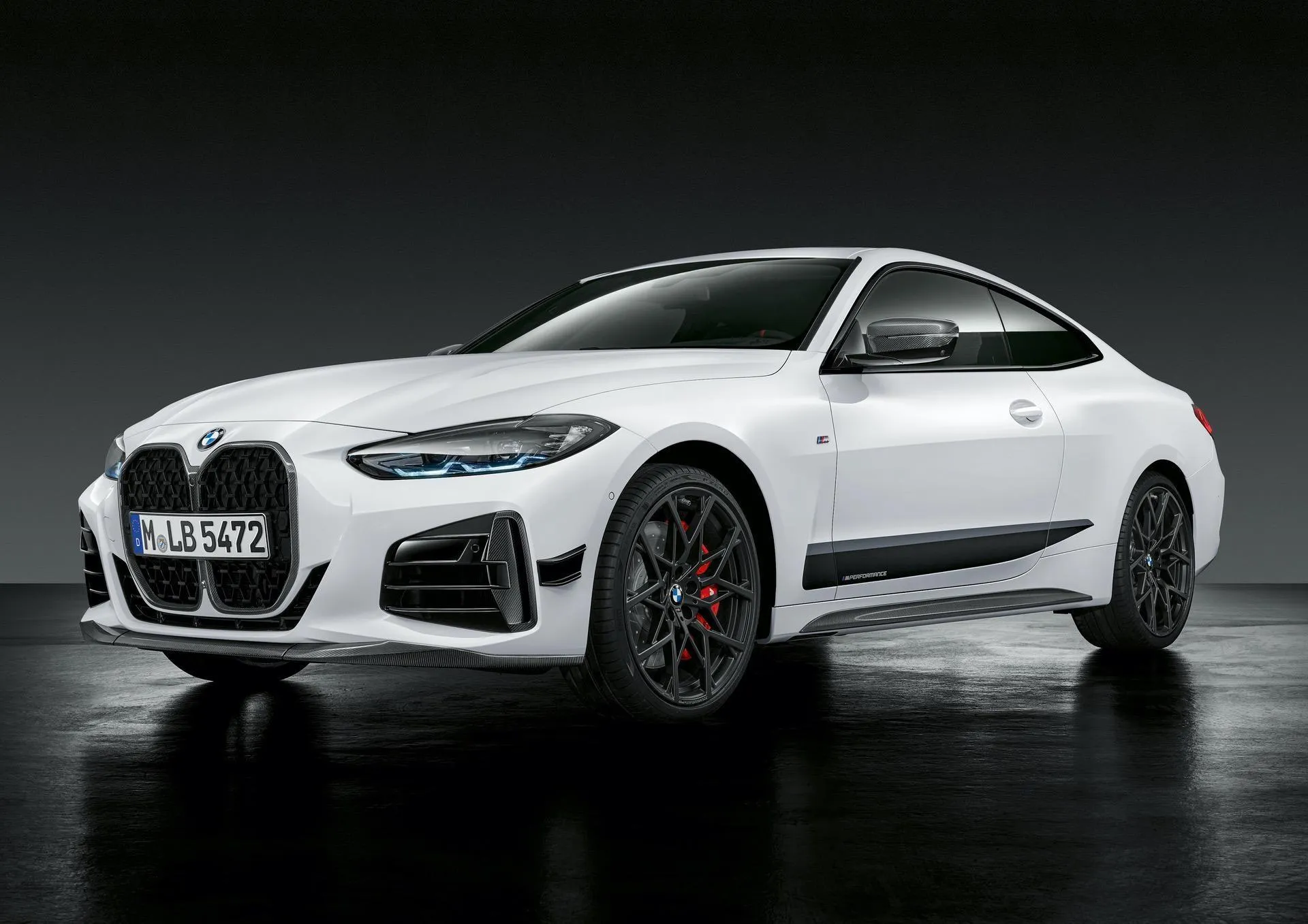 White Bmw Sedan Displayed Under Soft Studio Light Image