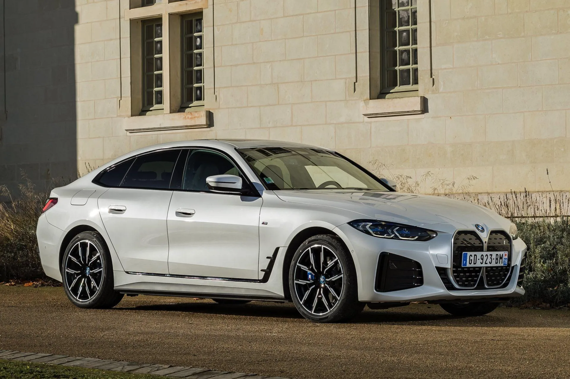 White Bmw Sedan Parked Beside Classic Stone Building
