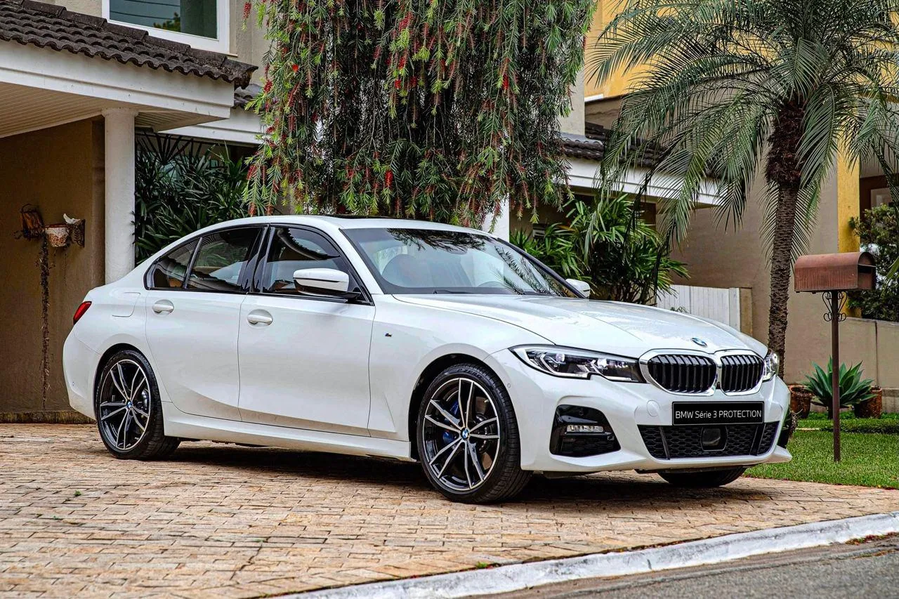 White Bmw Sedan Parked in Front of Modern Tropical Villa