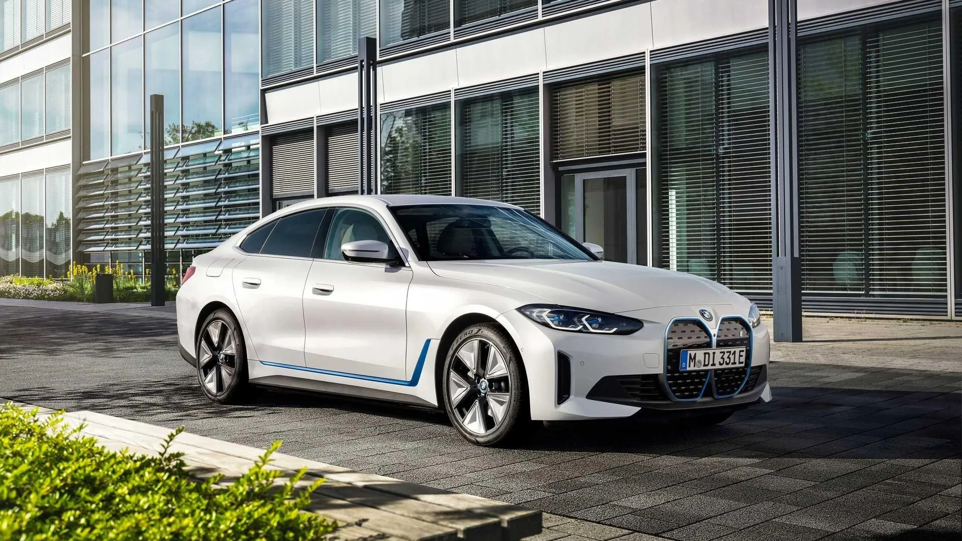 White Bmw Sedan Parked Near Modern Building in Daylight