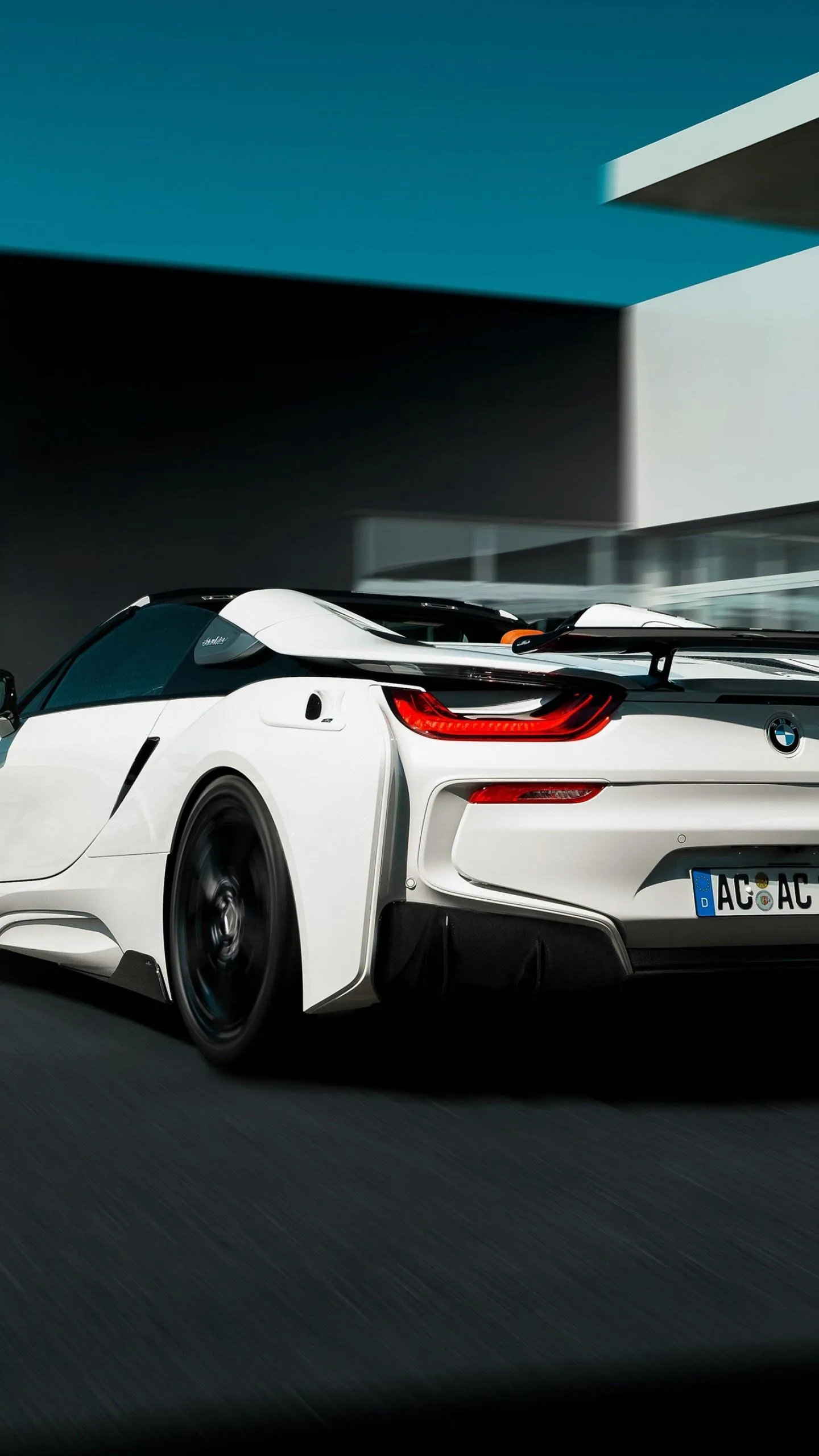 White Bmw Sports Car Parked Near Modern Building Image