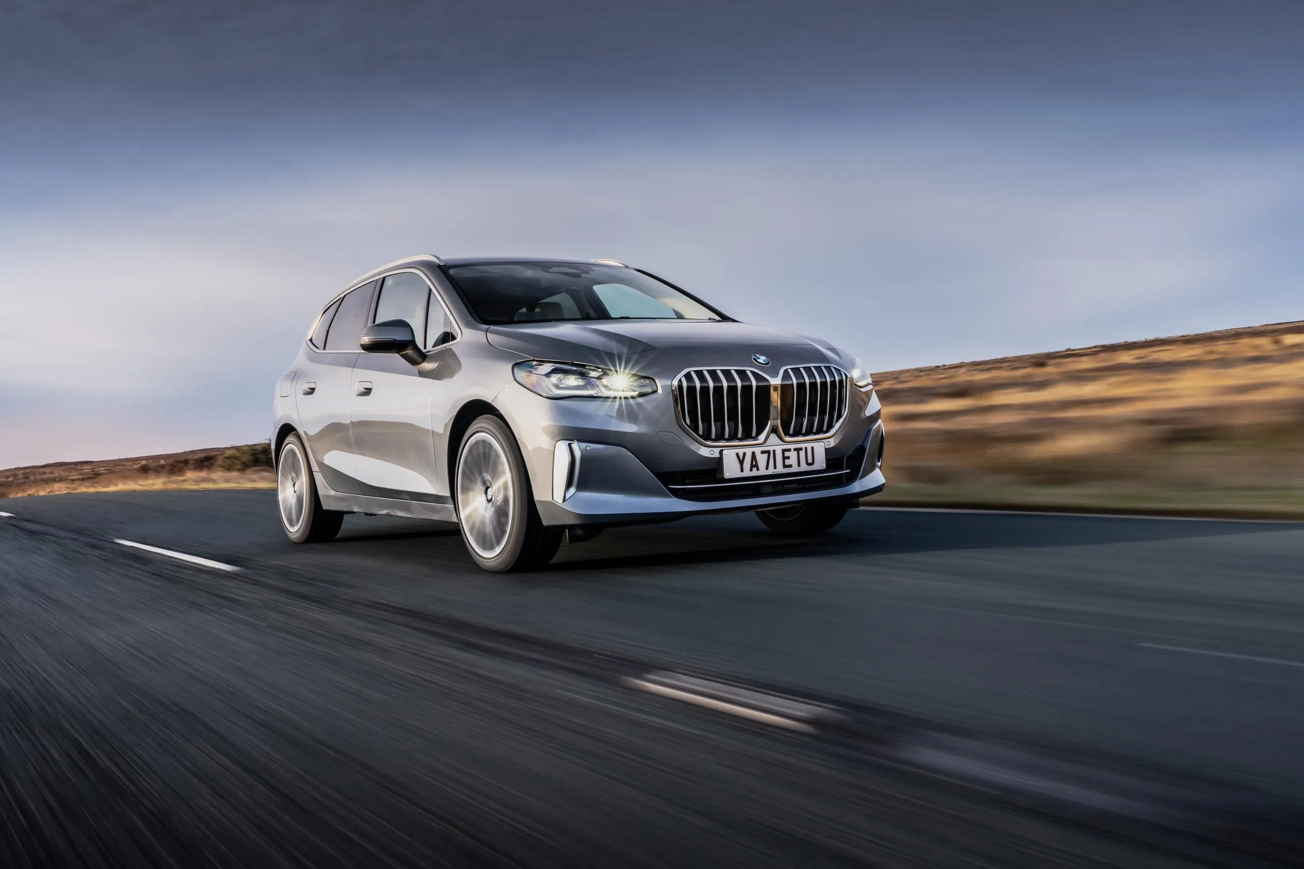 White Bmw Suv Driving on Highway with Sunset Sky Image