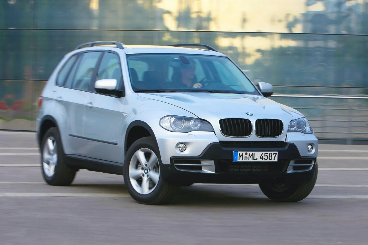 White Bmw Suv Driving Through City at Sunset Time Wallpaper