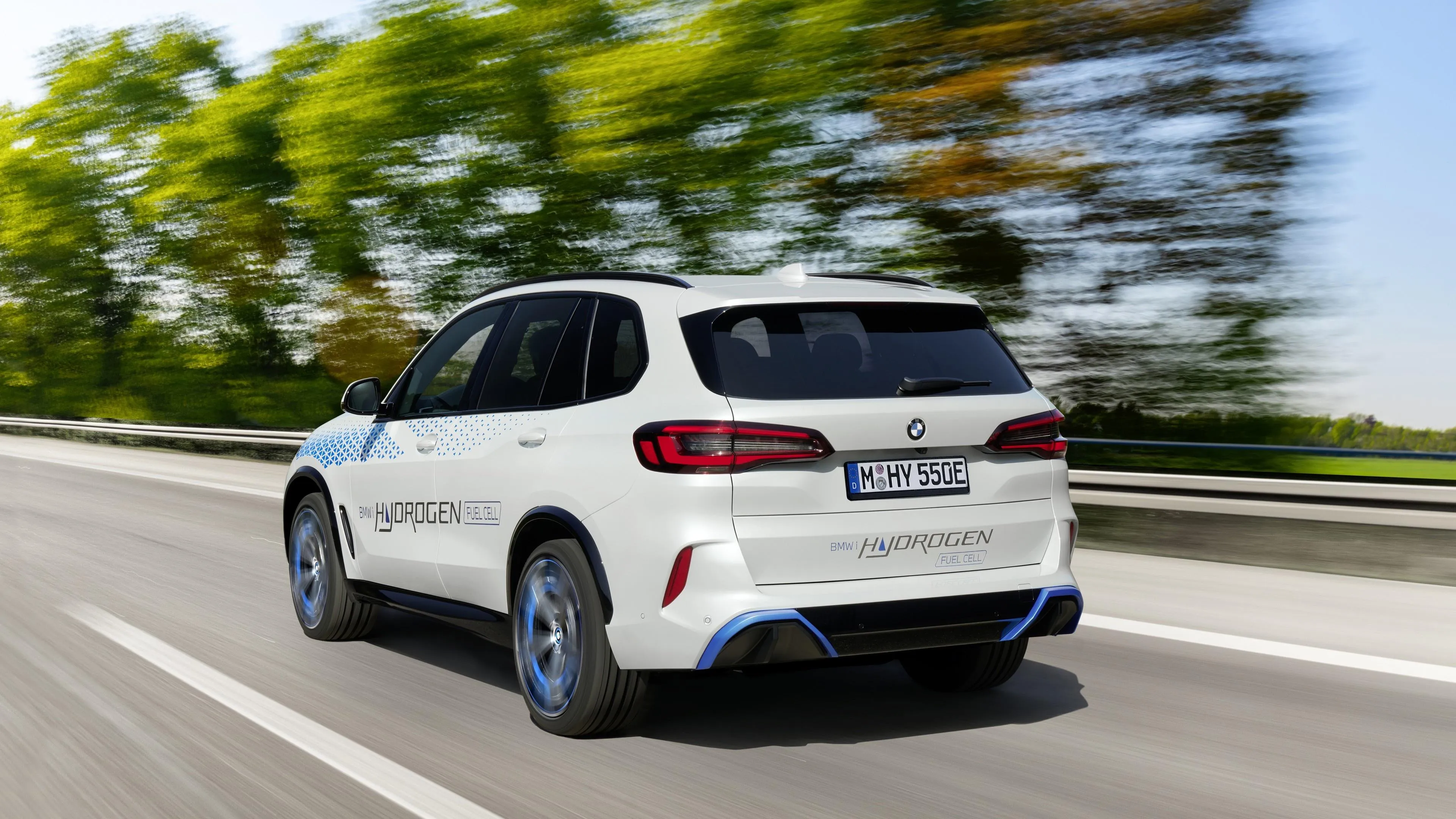 White Bmw Suv Driving Through Forest Road in Motion