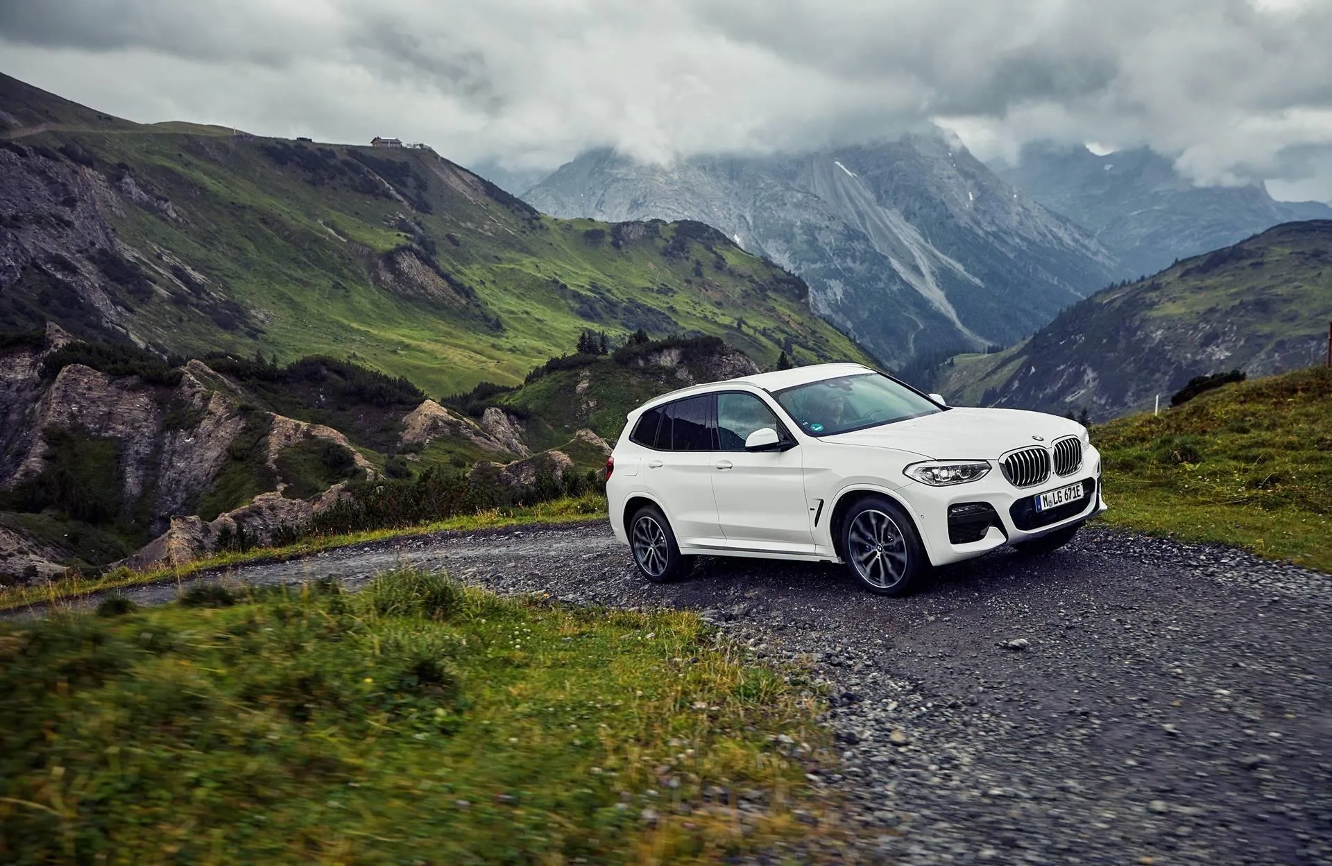 White Bmw Suv in Green Mountains with Cloudy Skies Hd