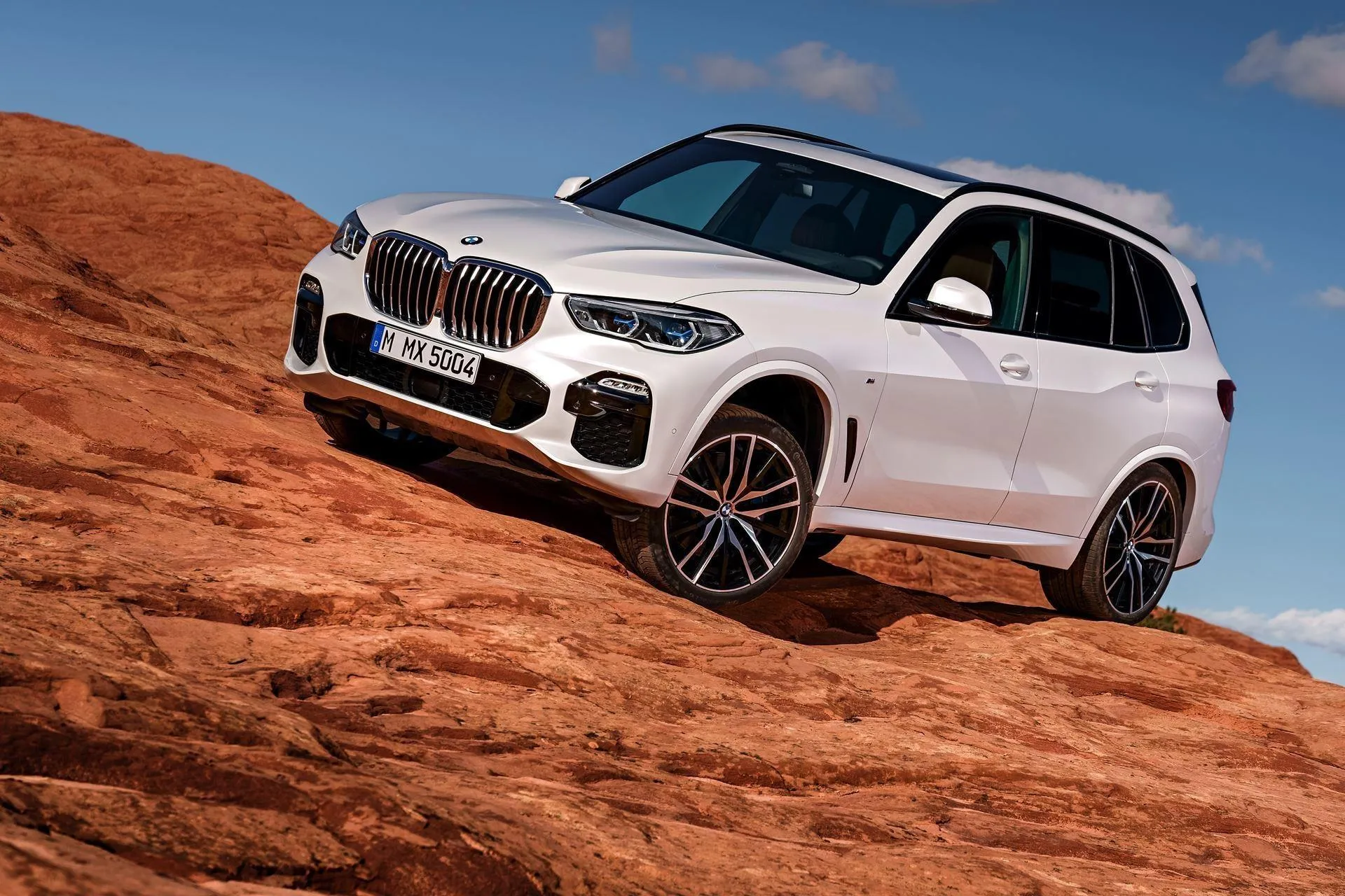 White Bmw Suv Parked on Red Rock Terrain in Desert 4K