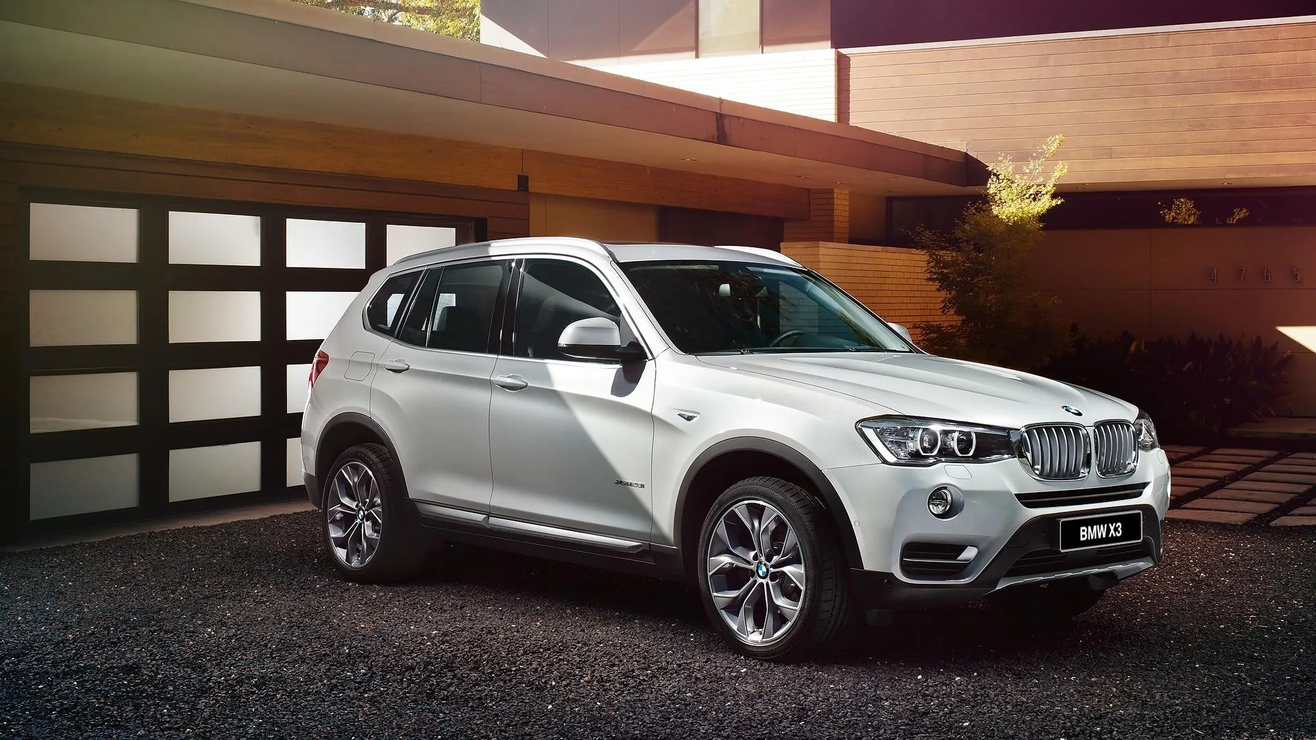 White Bmw Suv Parked Under Wooden Roof in Driveway