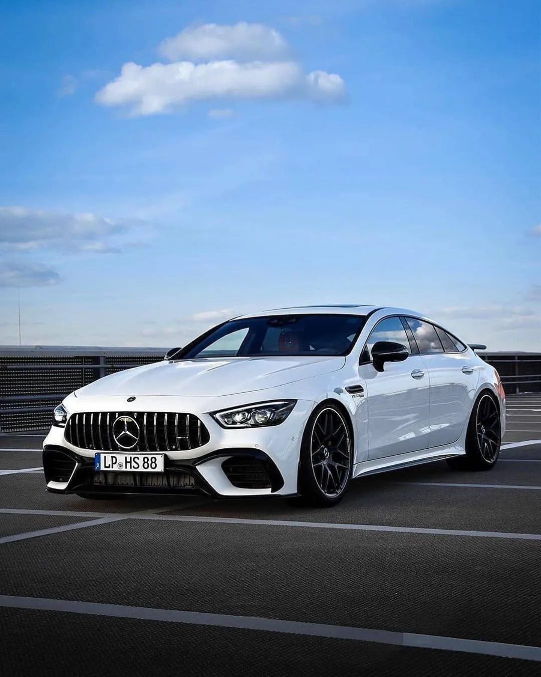 White Mercedes AMG Coupe in Open Parking Lot Wallpaper