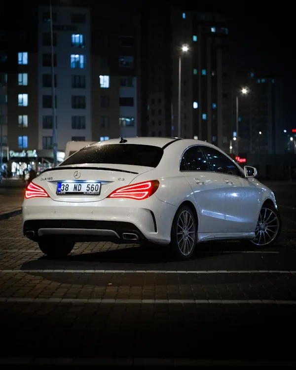 White Mercedes Benz Car Driving at Night City Wallpaper