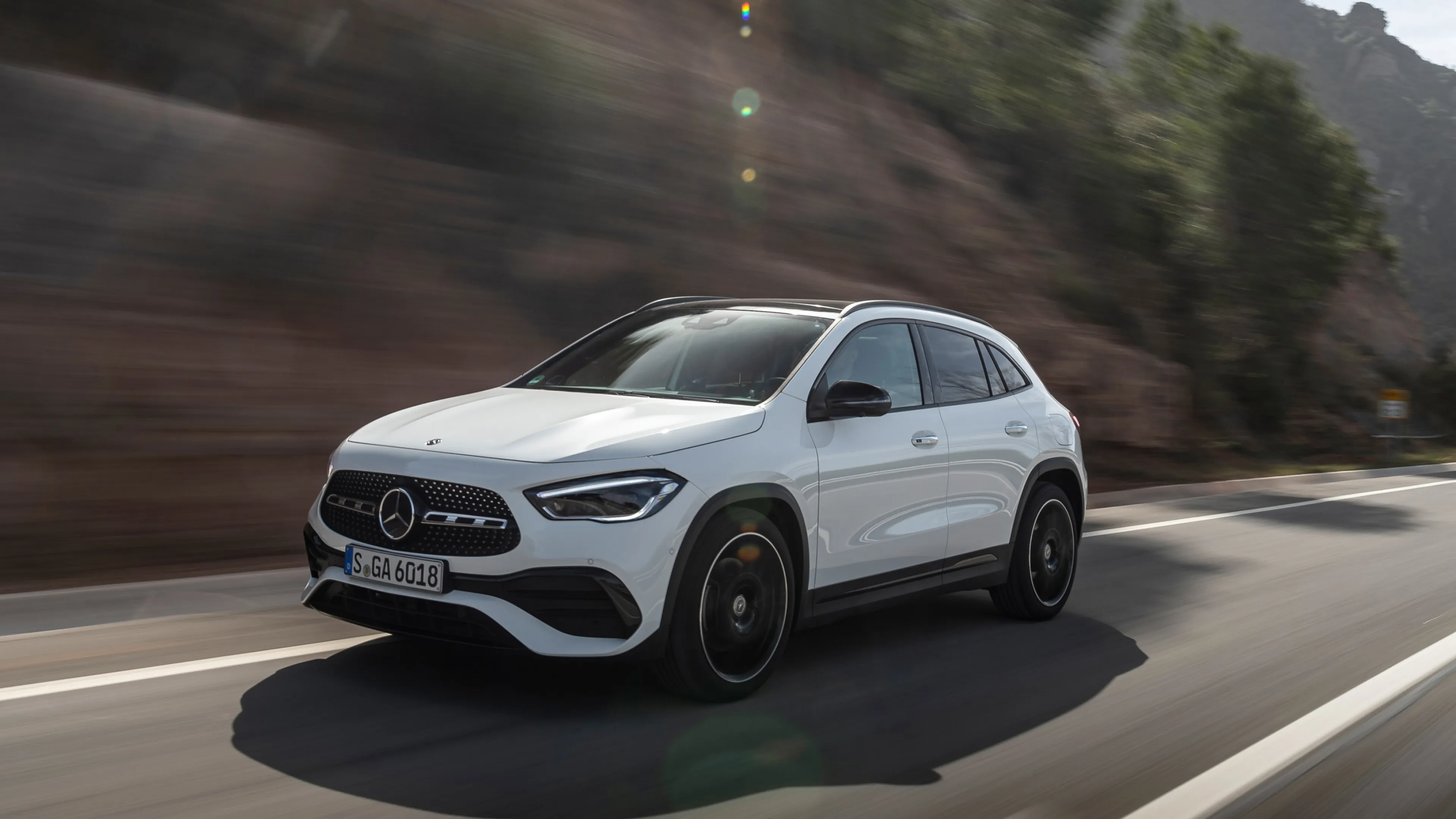 White Mercedes Benz Compact SUV Driving on Mountain Road