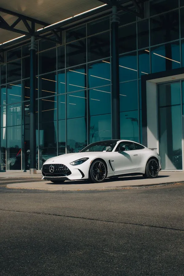 White Mercedes Benz Convertible Parked at Glass Office
