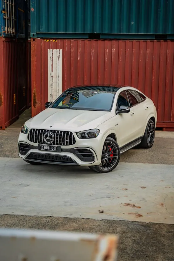 White Mercedes Benz Coupe Near Shipping Containers Wallpaper