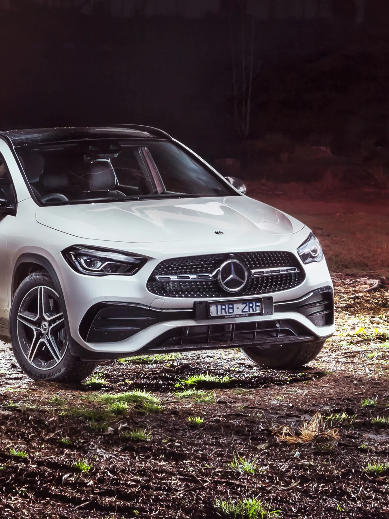 White Mercedes Benz Crossover on Rocky Terrain at Sunset