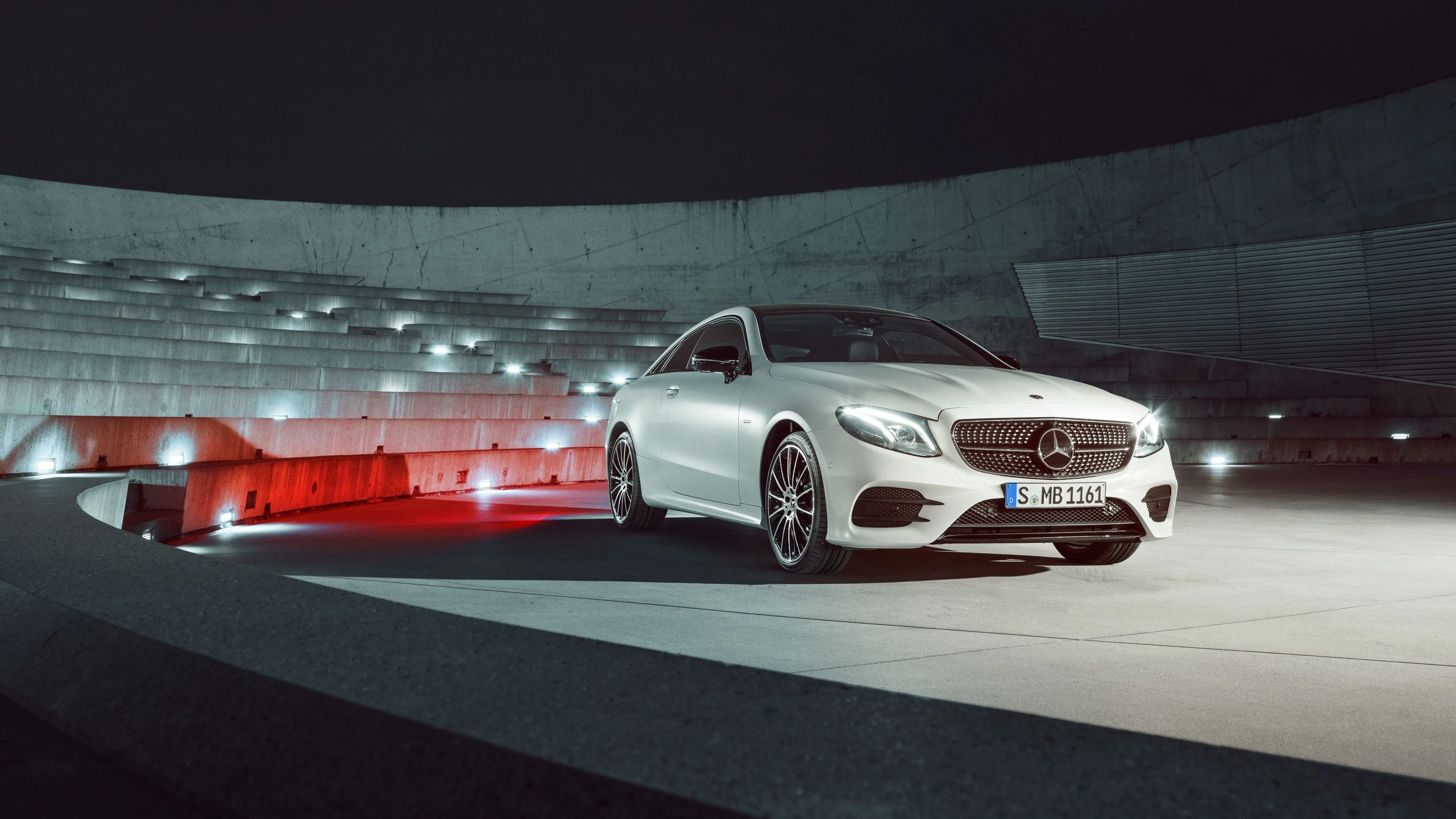 White Mercedes Benz Driving Fast on a Curved Road
