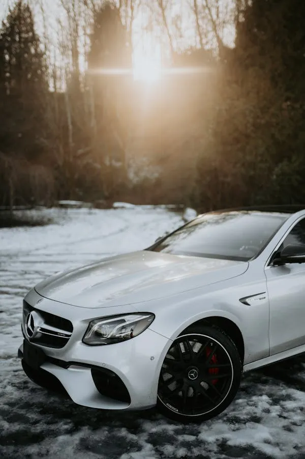 White Mercedes Benz Parked in Snow Covered Forest Area