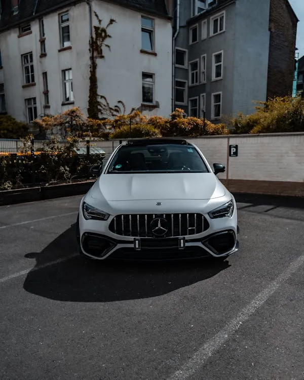 White Mercedes Benz Parked on Street with Buildings free image