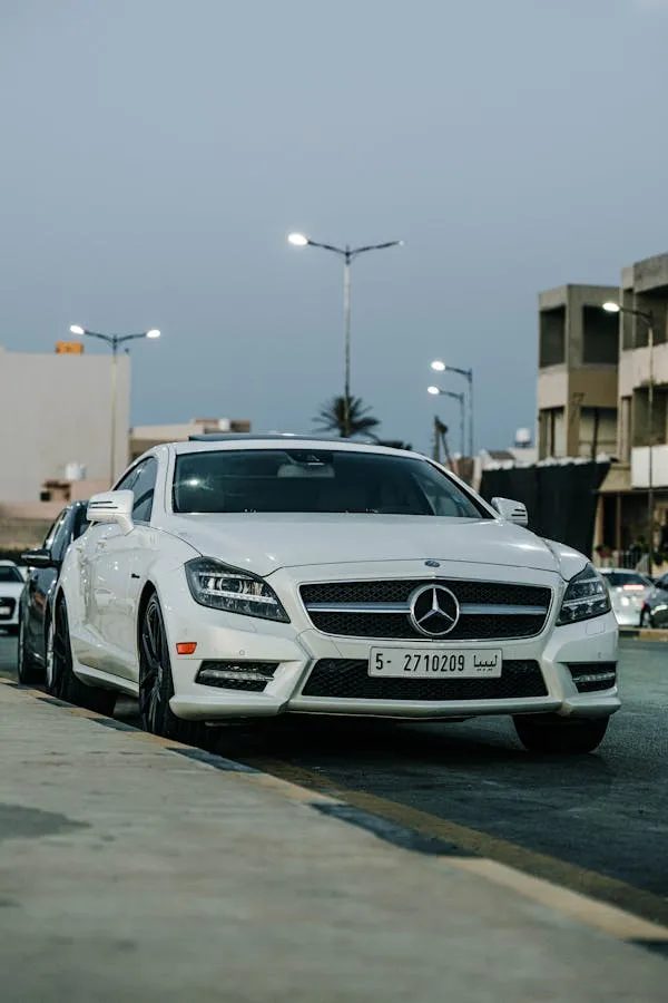 White Mercedes Benz Parked on Urban Roadside Wallpaper