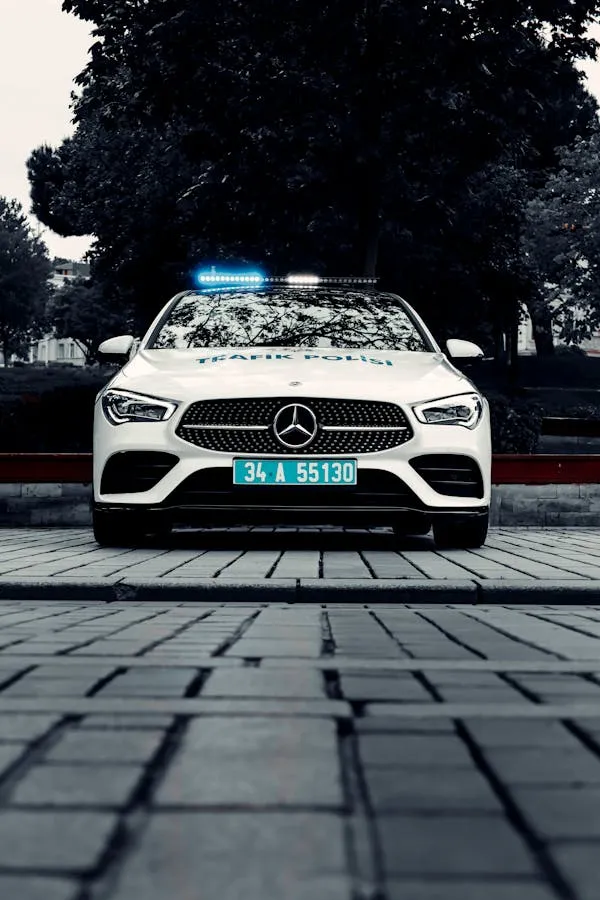 White Mercedes Benz Police Car on Paved Road Wallpaper