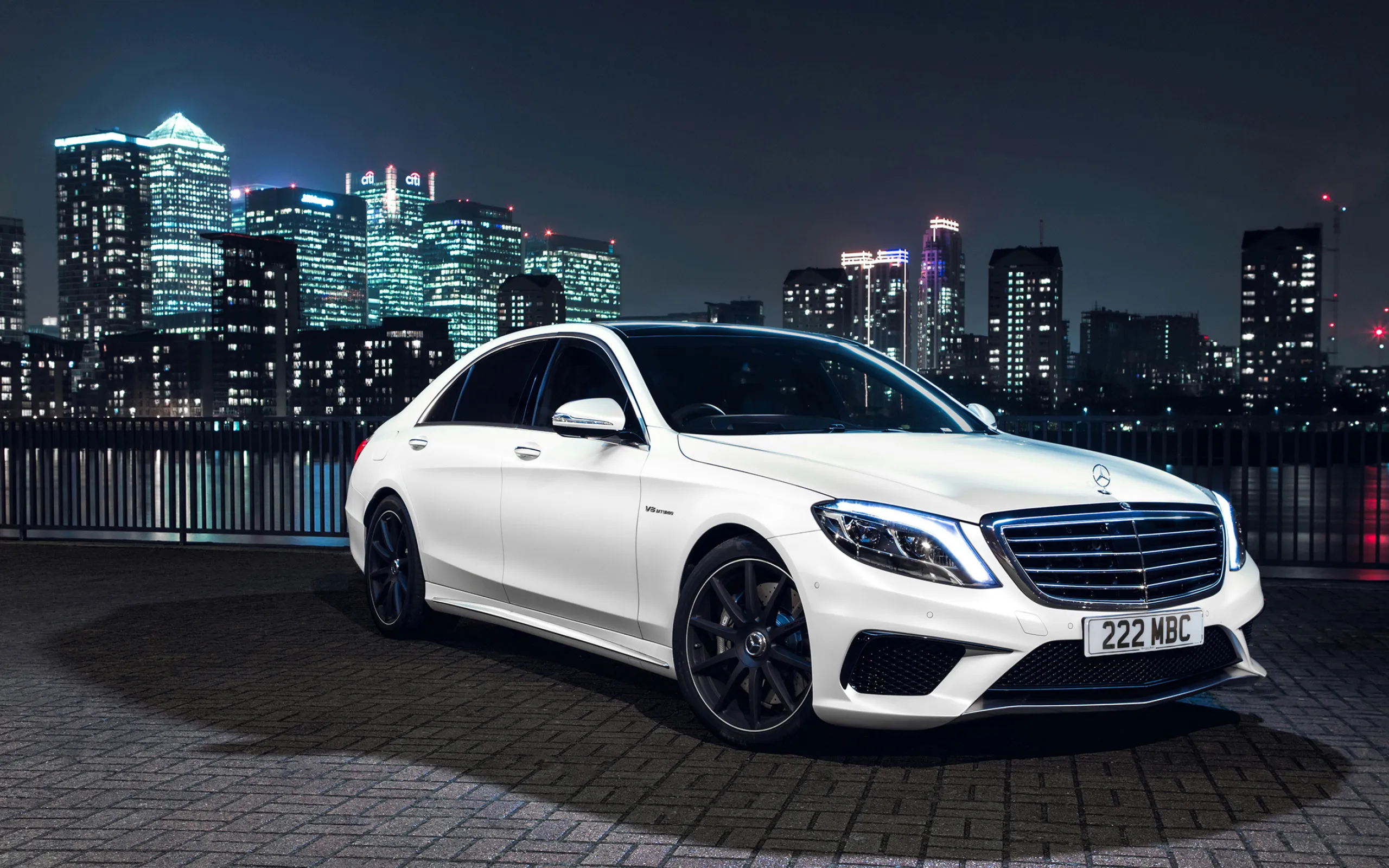 White Mercedes Benz Sedan at Night in Urban Cityscape