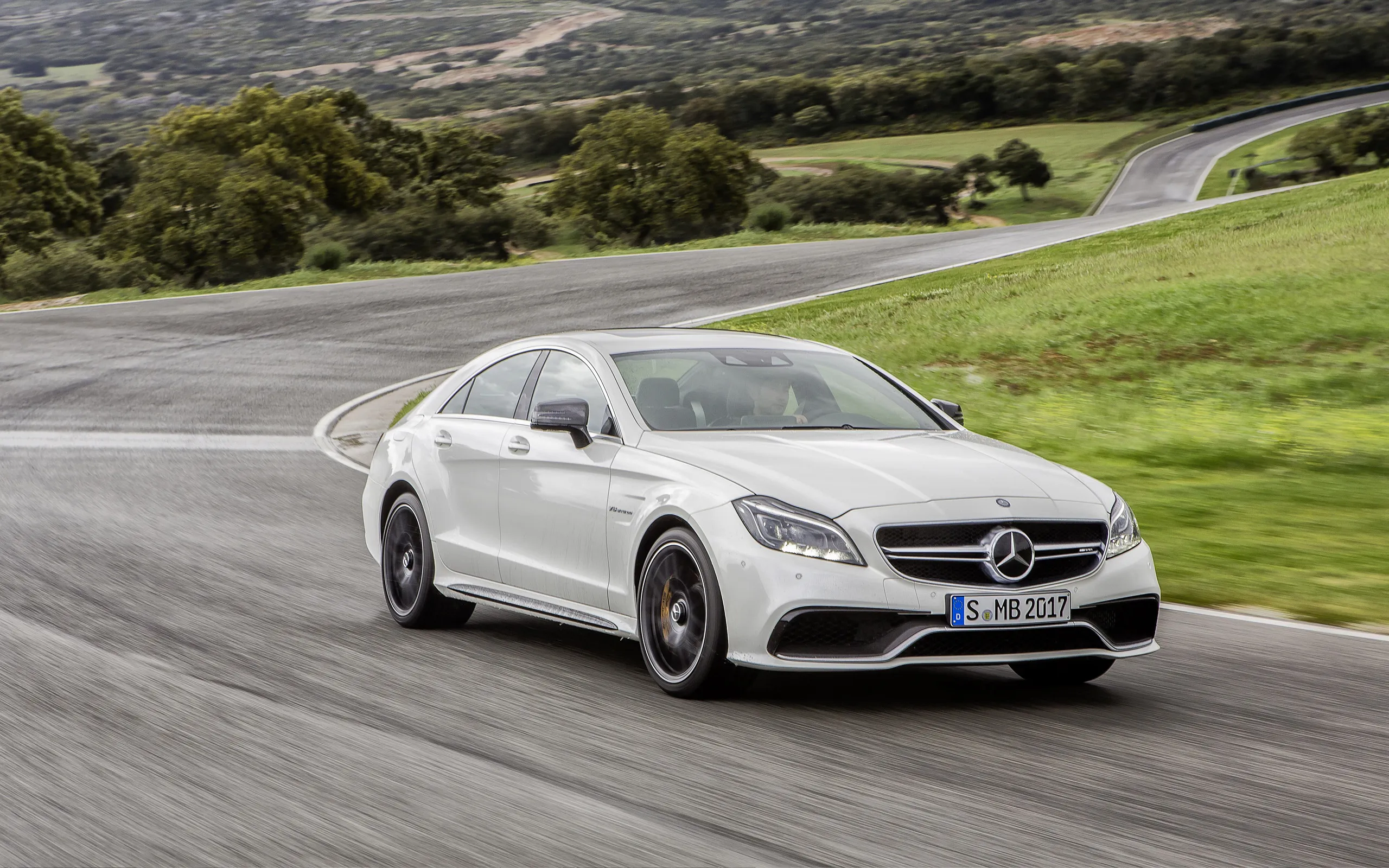 White Mercedes Benz Sedan Driving on Curvy Country Road