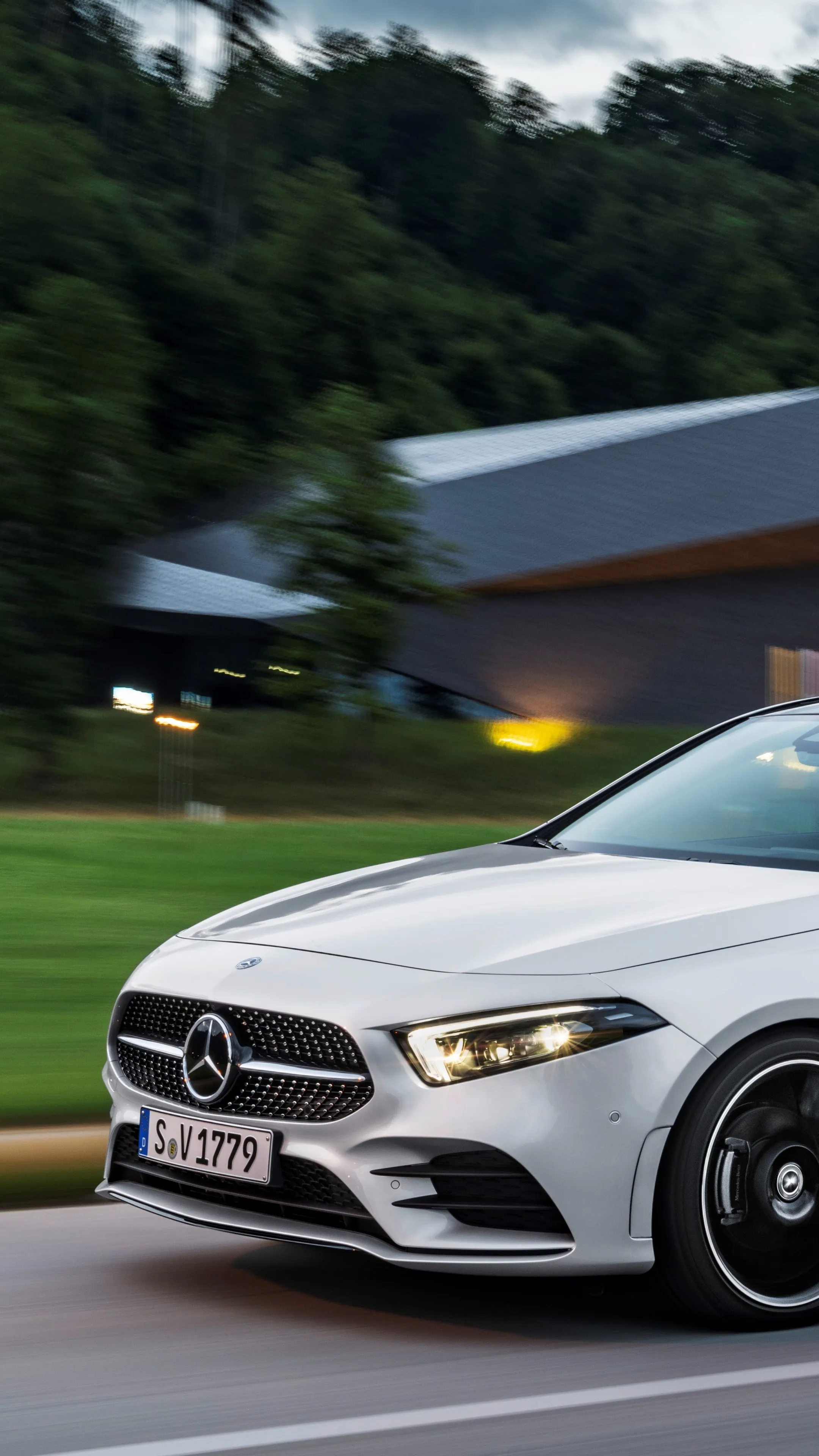 White Mercedes Benz Sedan Driving Through Greenery