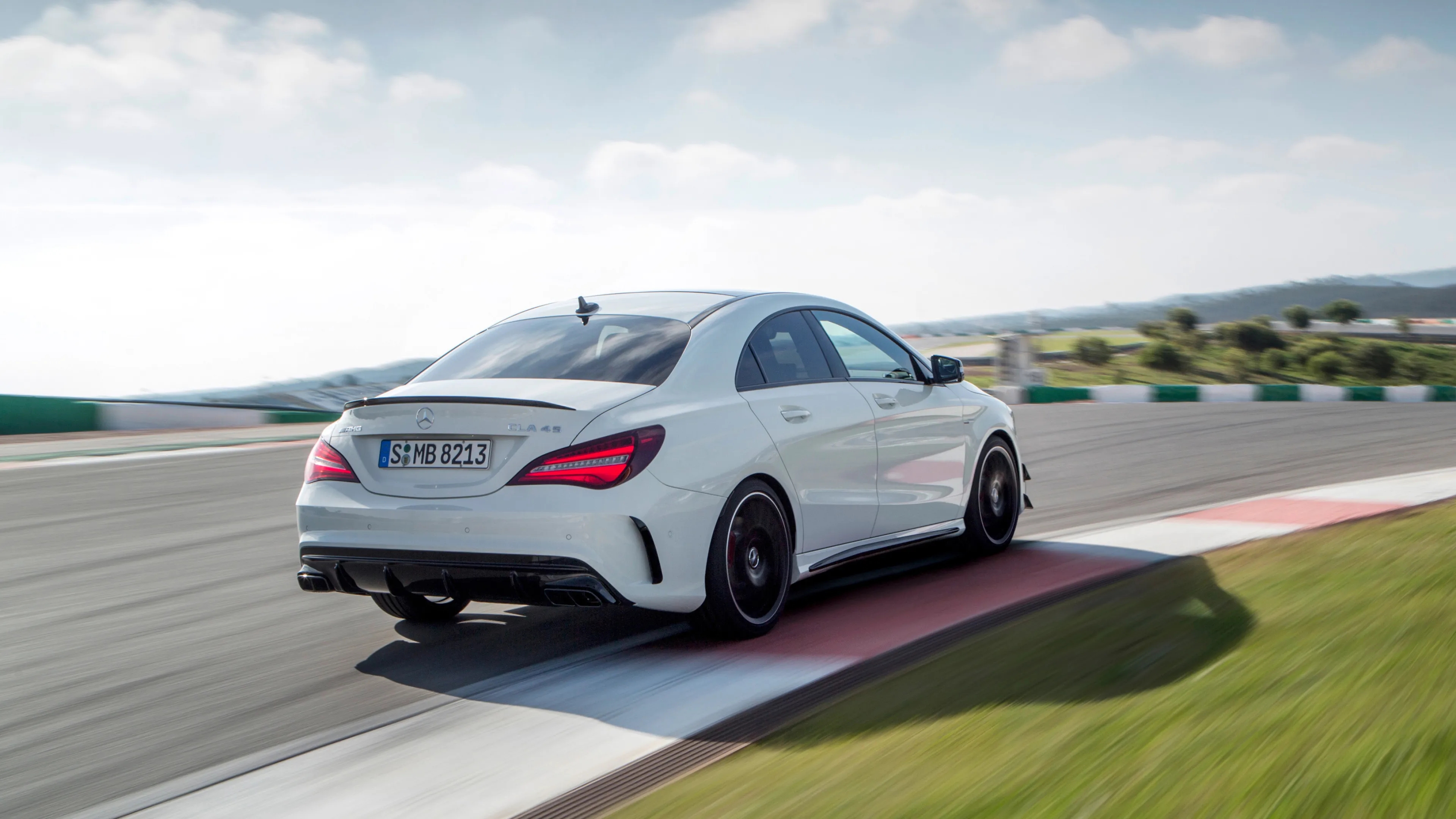 White Mercedes Benz Sedan Turning Sharp on Raceway Wallpaper