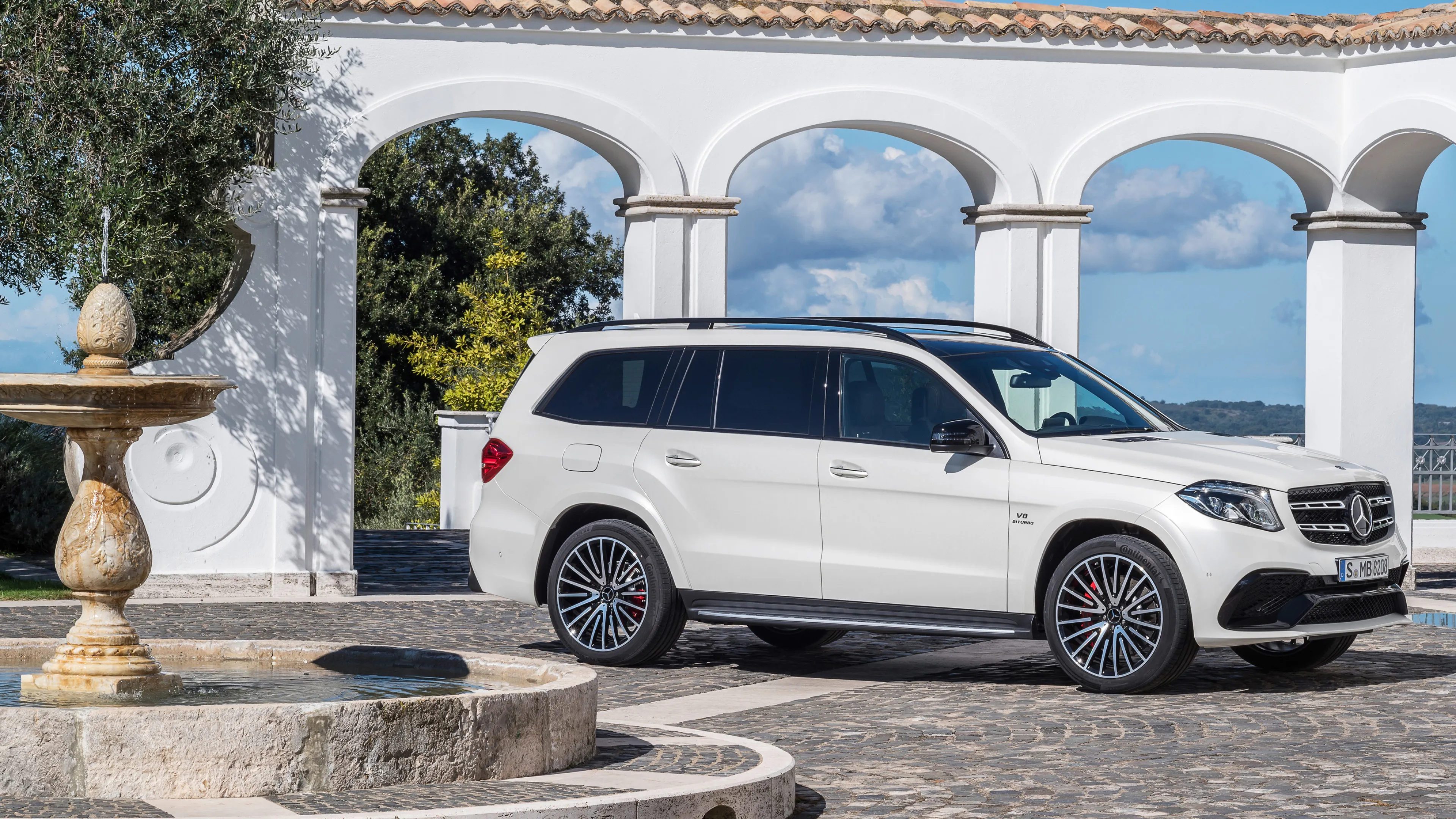 White Mercedes Benz SUV Displayed by Classic Columns