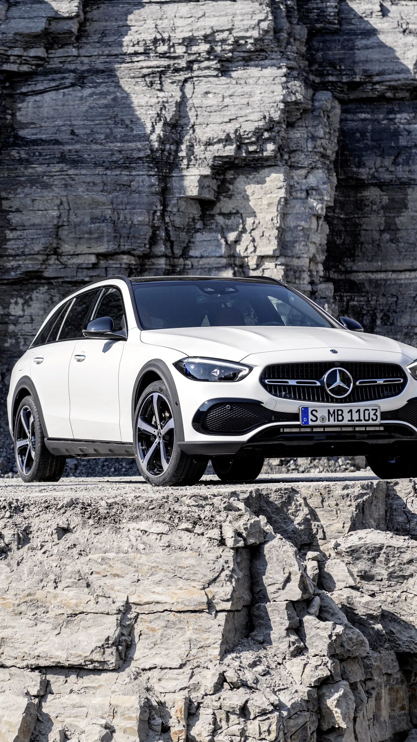 White Mercedes Benz SUV Parked by Rock Cliff Wallpaper
