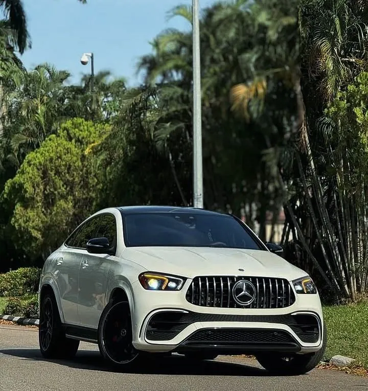 White Mercedes Benz SUV Parked in Sunny Green Area image