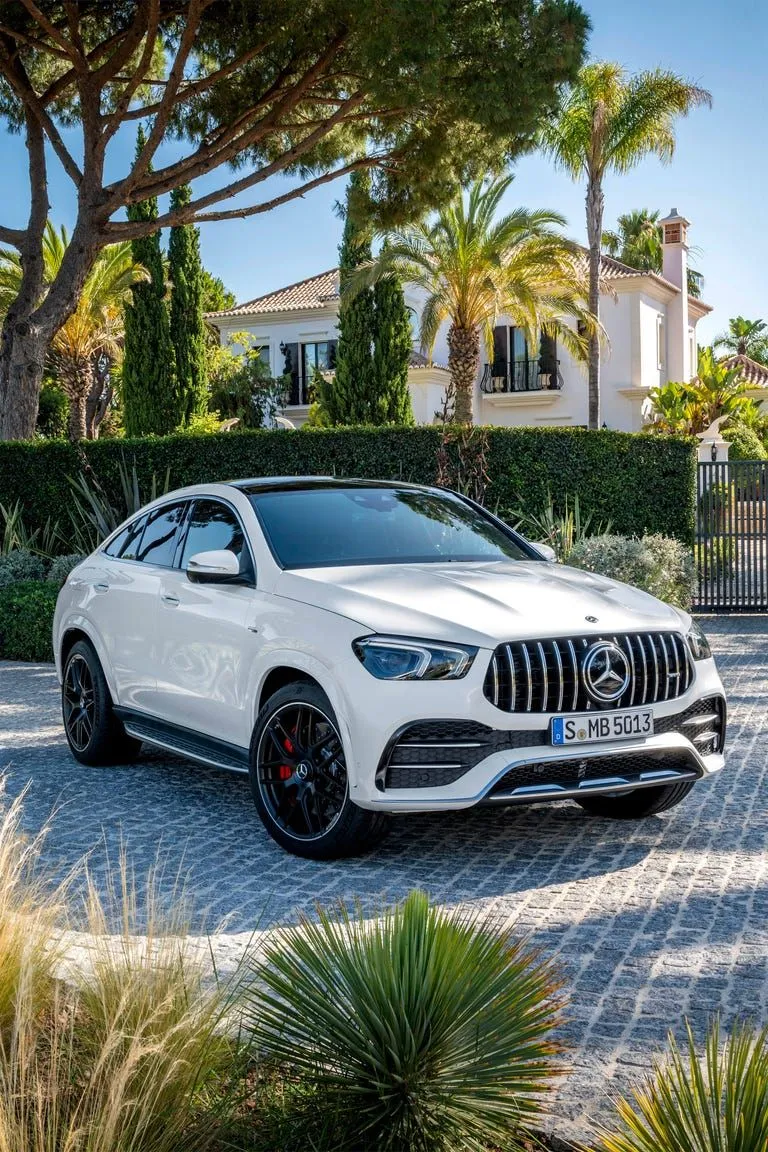 White Mercedes Benz SUV Parked near Residential Homes
