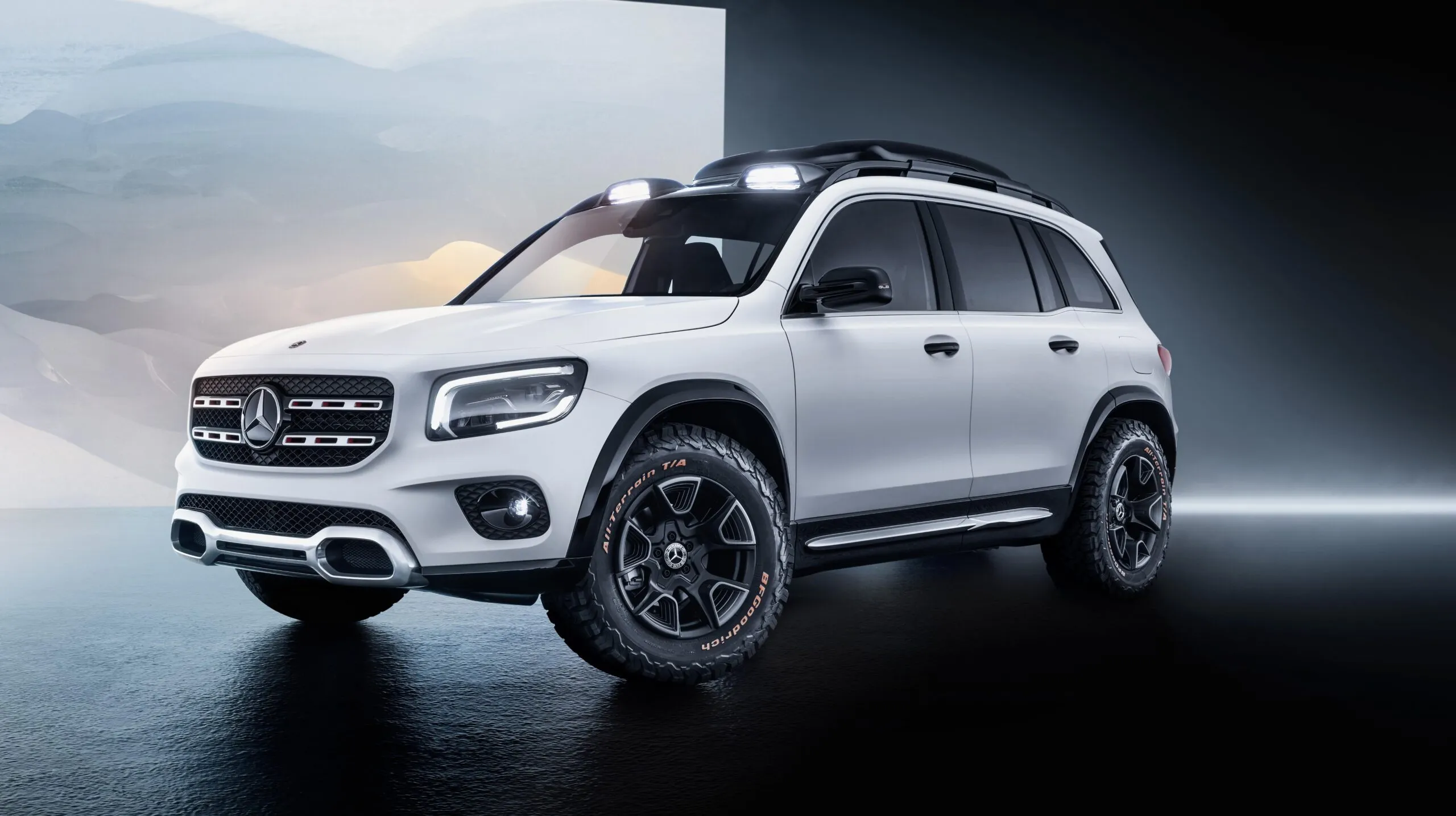 White Mercedes Benz SUV with rugged tires on display